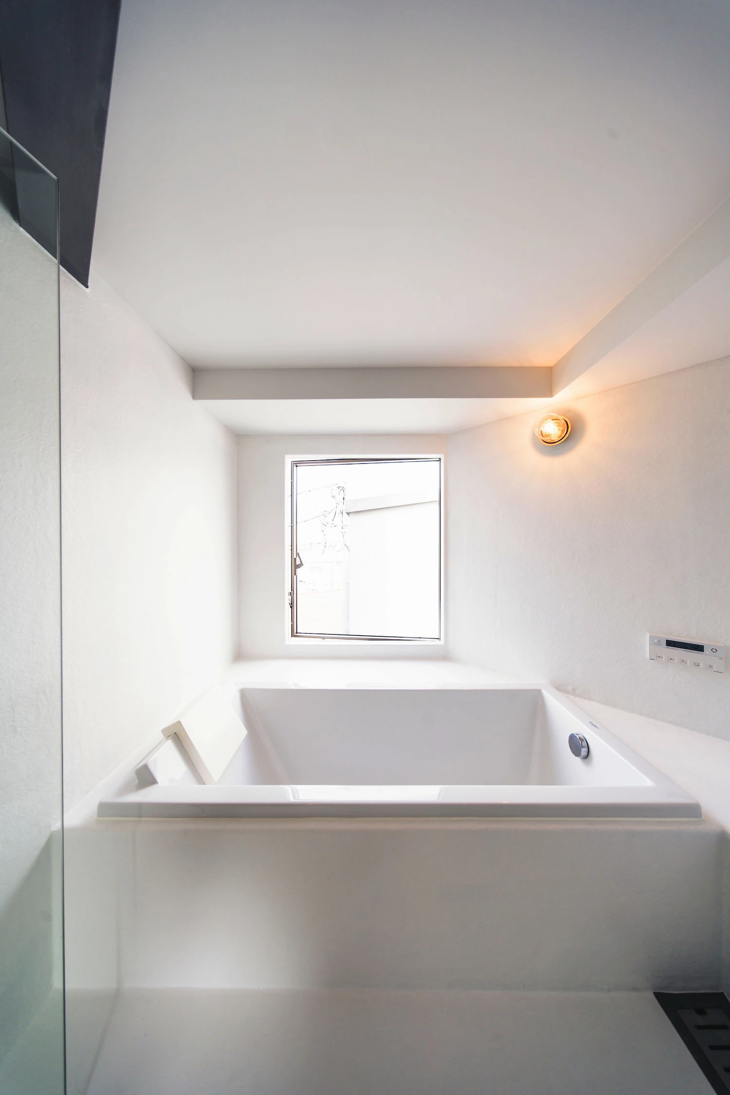 Bay Window Tower House by Takaaki Fuji + Yuko Fuji Architecture — A recessed bay window bathroom demonstrates the project's core strategy—the building's inhabitable edge.