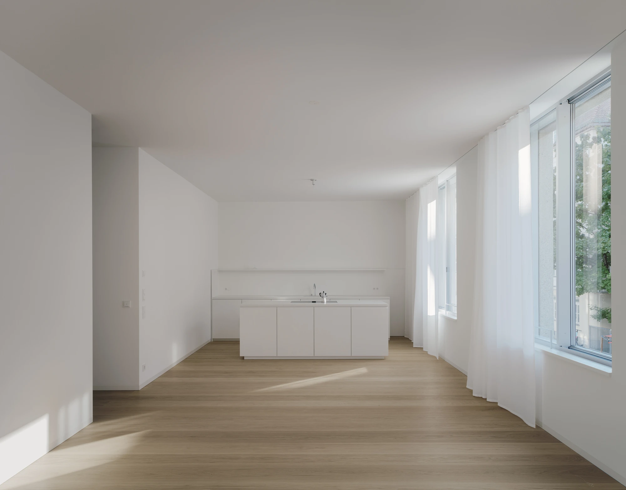 Ursulastraße 6 by Studio Mark Randel — An open-plan kitchen and living space flooded with natural light from full-height glazed doors and windows.