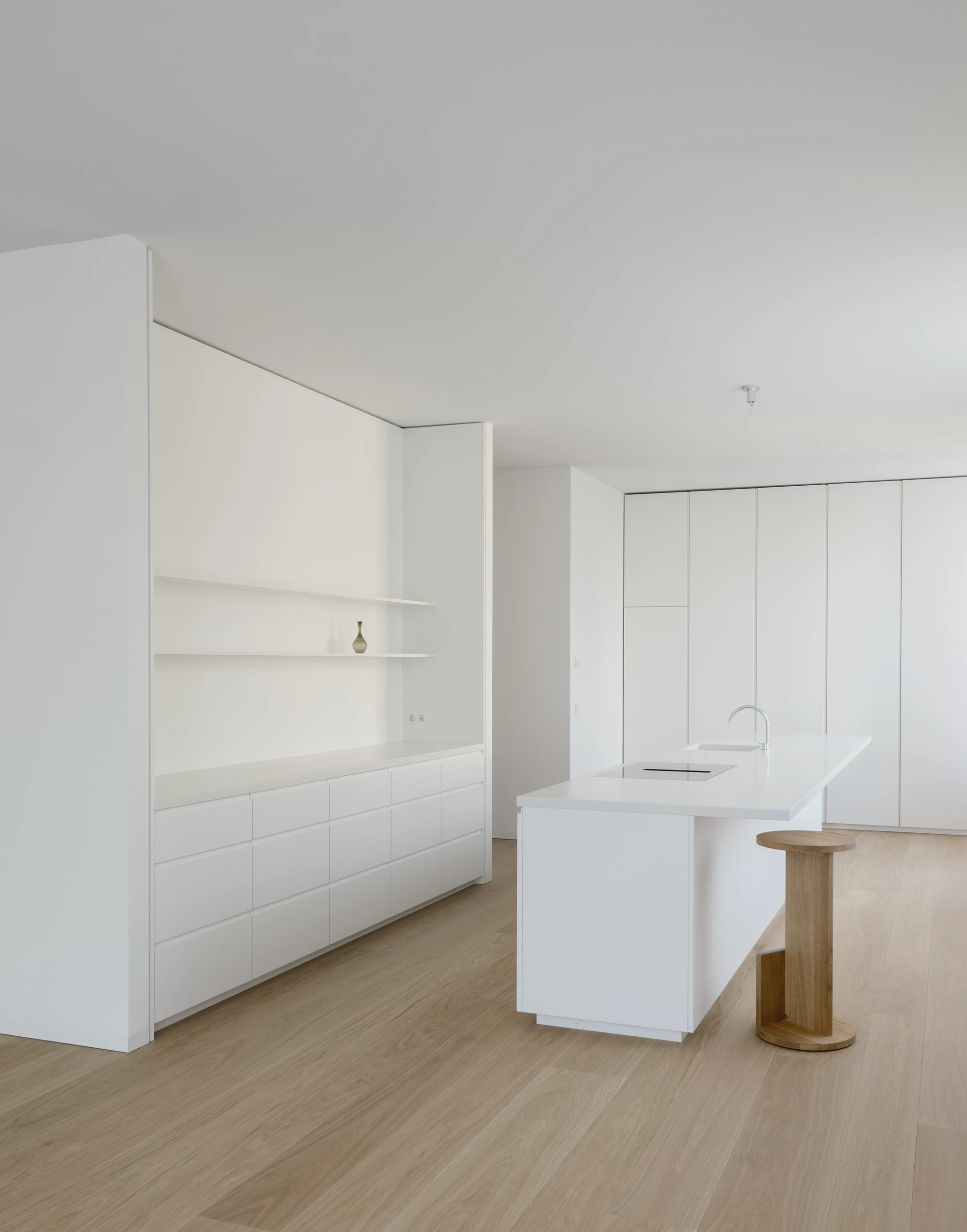 Ursulastraße 6 by Studio Mark Randel — A kitchen interior defined by modular white cabinetry and minimal detailing.