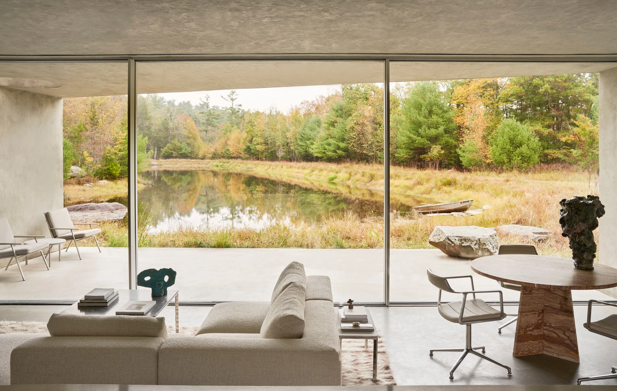 Vipp Upstate by Johnston Marklee — Floor-to-ceiling glazing frames a panoramic landscape view of the Catskill meadow and pond beyond.
