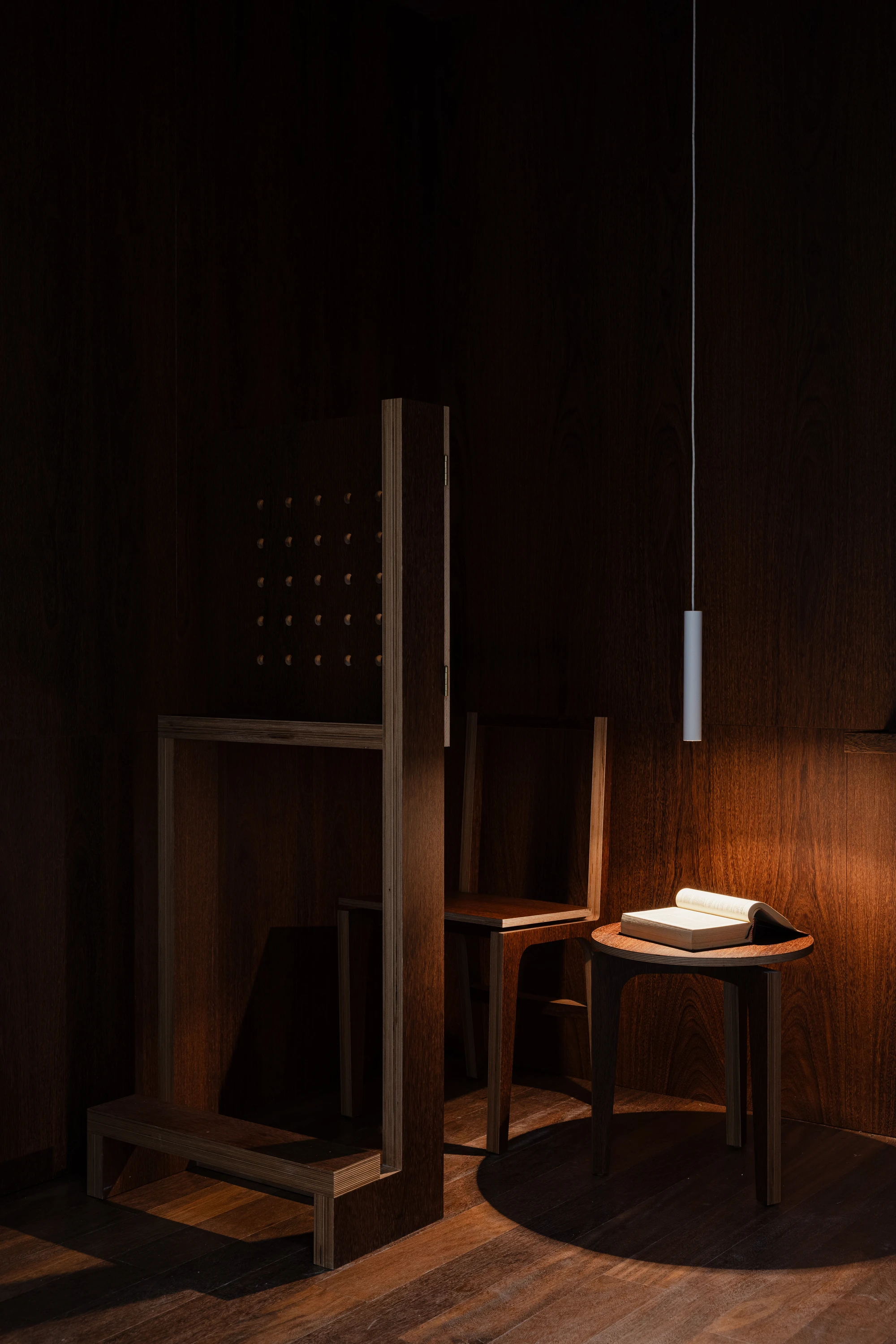 Da Boavista Church by Matos Gameiro arquitectos + atelier bugio — Interior view of a confessional booth constructed from dark timber with geometric precision.