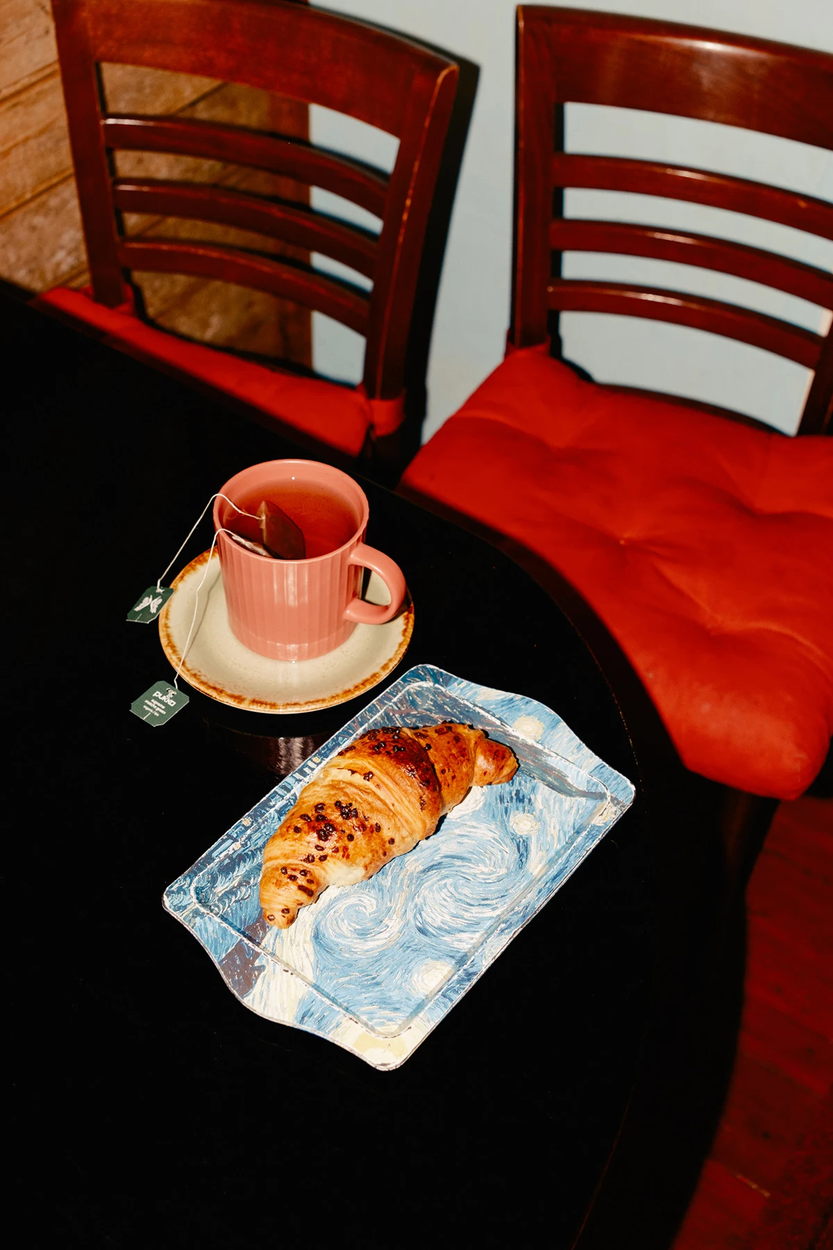Lupine by Daniel Dorsa — A still life staged on black fabric depicts the quotidian aftermath of displacement.
