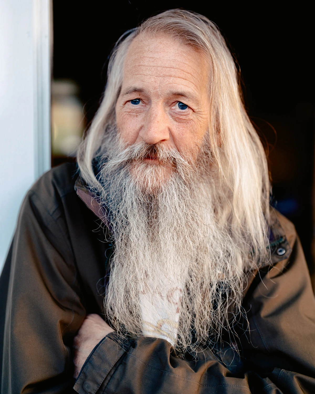 Lupine by Daniel Dorsa — Portrait of an elderly man with an exceptionally long, full white beard extending past his chest, paired with shoulder-length white hair.