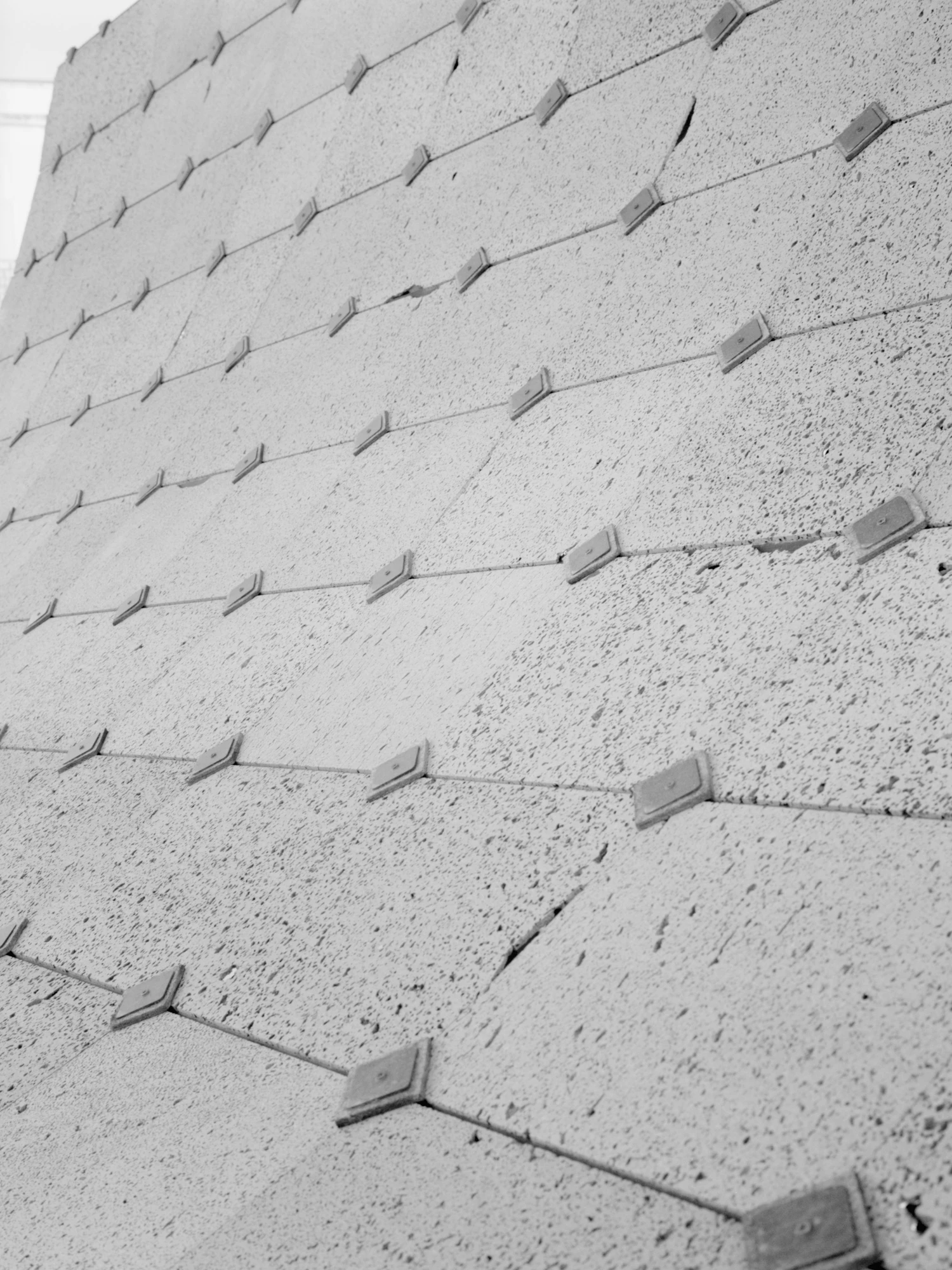 Pantalica Speculations by Leopold Banchini — Close-up detail of the pavilion's concrete foundation platform, revealing the systematic anchoring system that secures the billowing white fabric roof.