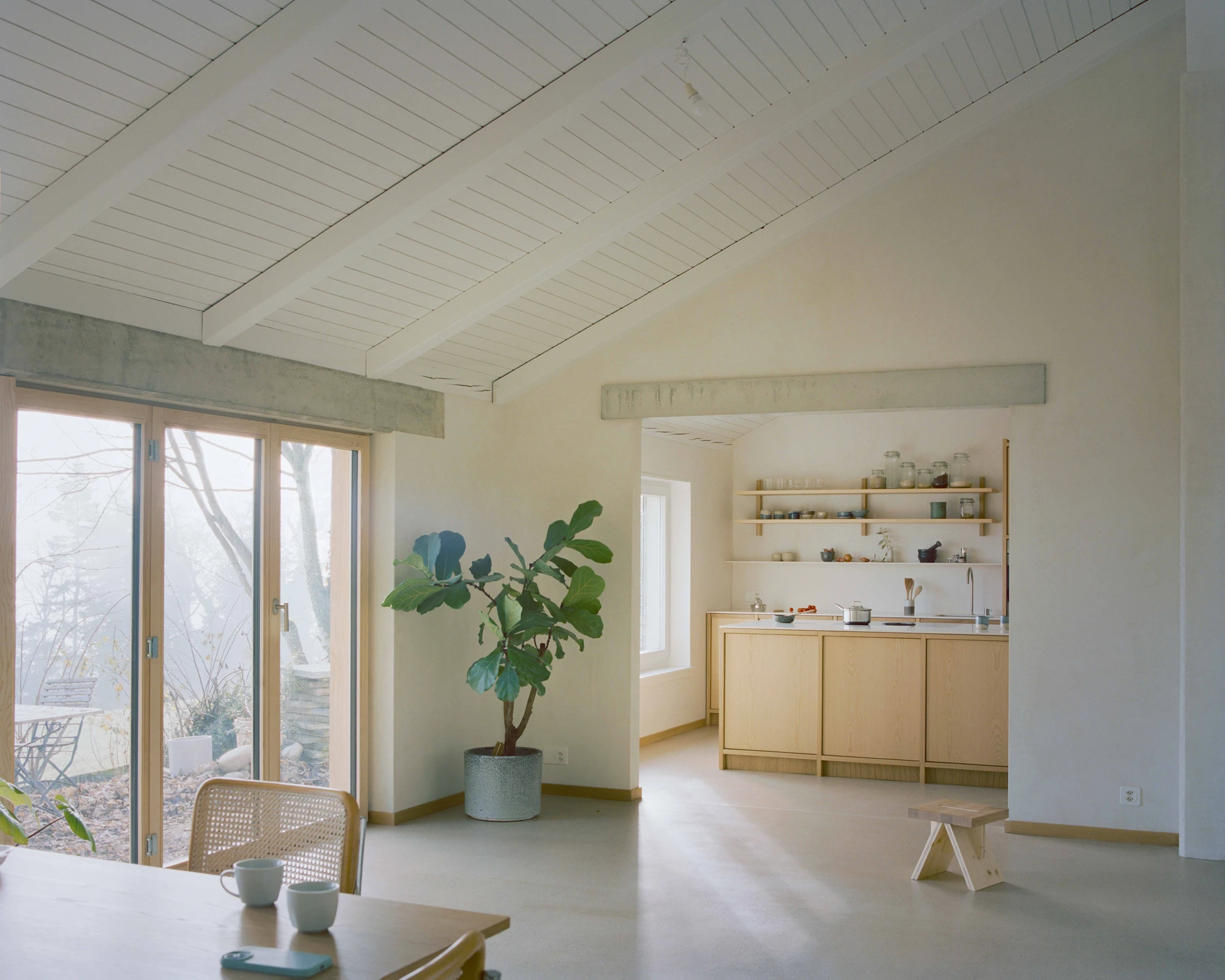 Family Villa by Noue Studio — A reconfigured family villa interior demonstrates spatial reorganization through material simplicity and visual continuity.