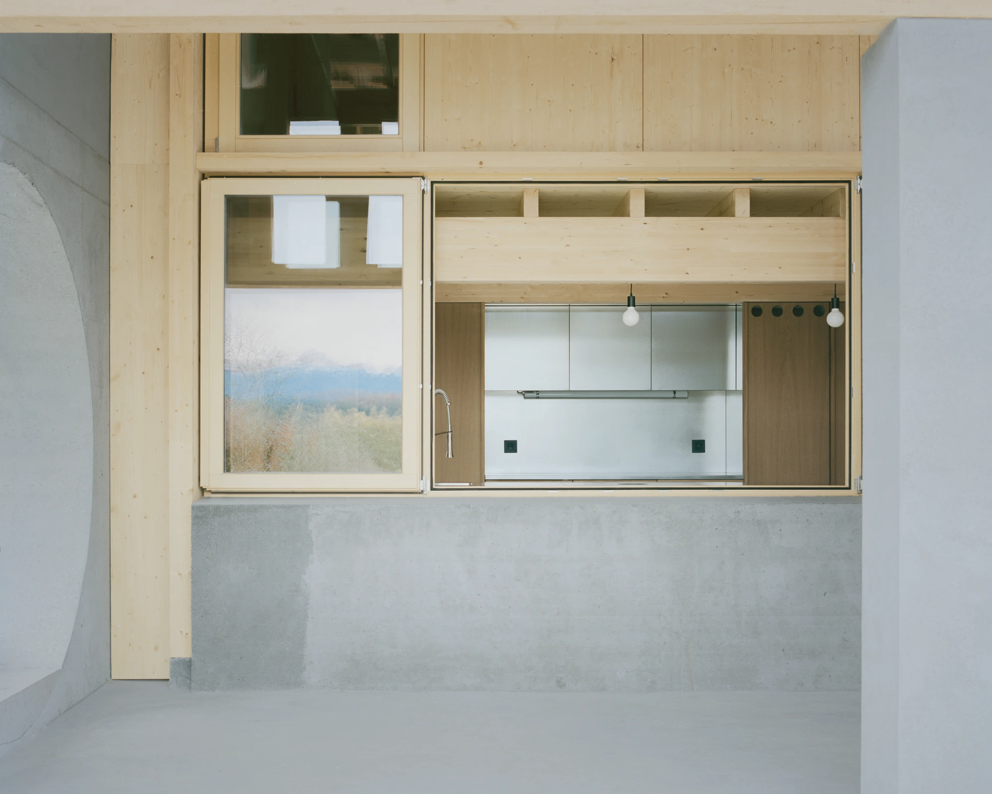 The Inverted Farm by BARD YERSIN Architectes — Overhead view of a kitchen intervention within a repurposed Swiss farmhouse, revealing the inverted program at the project's core.