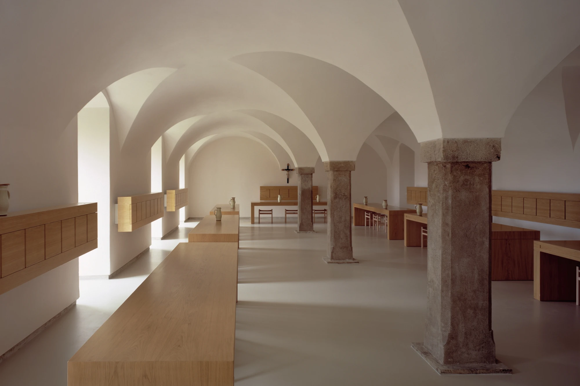 Abbey of Our Lady of Nový Dvůr by John Pawson — The nave extends rectilinear beneath a series of barrel-vaulted bays, their white plaster surfaces defining continuous spatial rhythm.