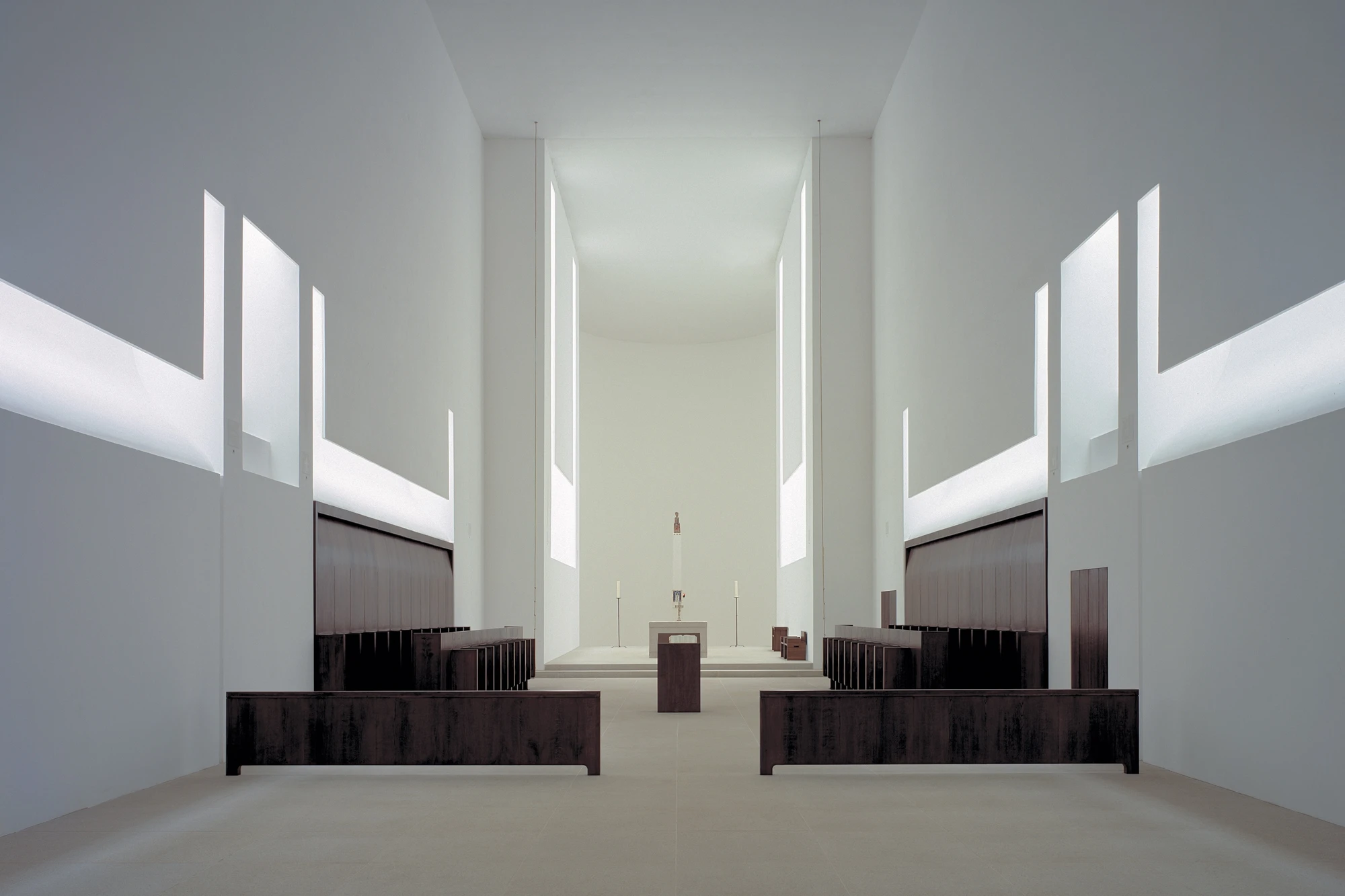 Abbey of Our Lady of Nový Dvůr by John Pawson — The nave of Abbey of Our Lady of Nový Dvůr extends toward the altar in rigorous symmetry.