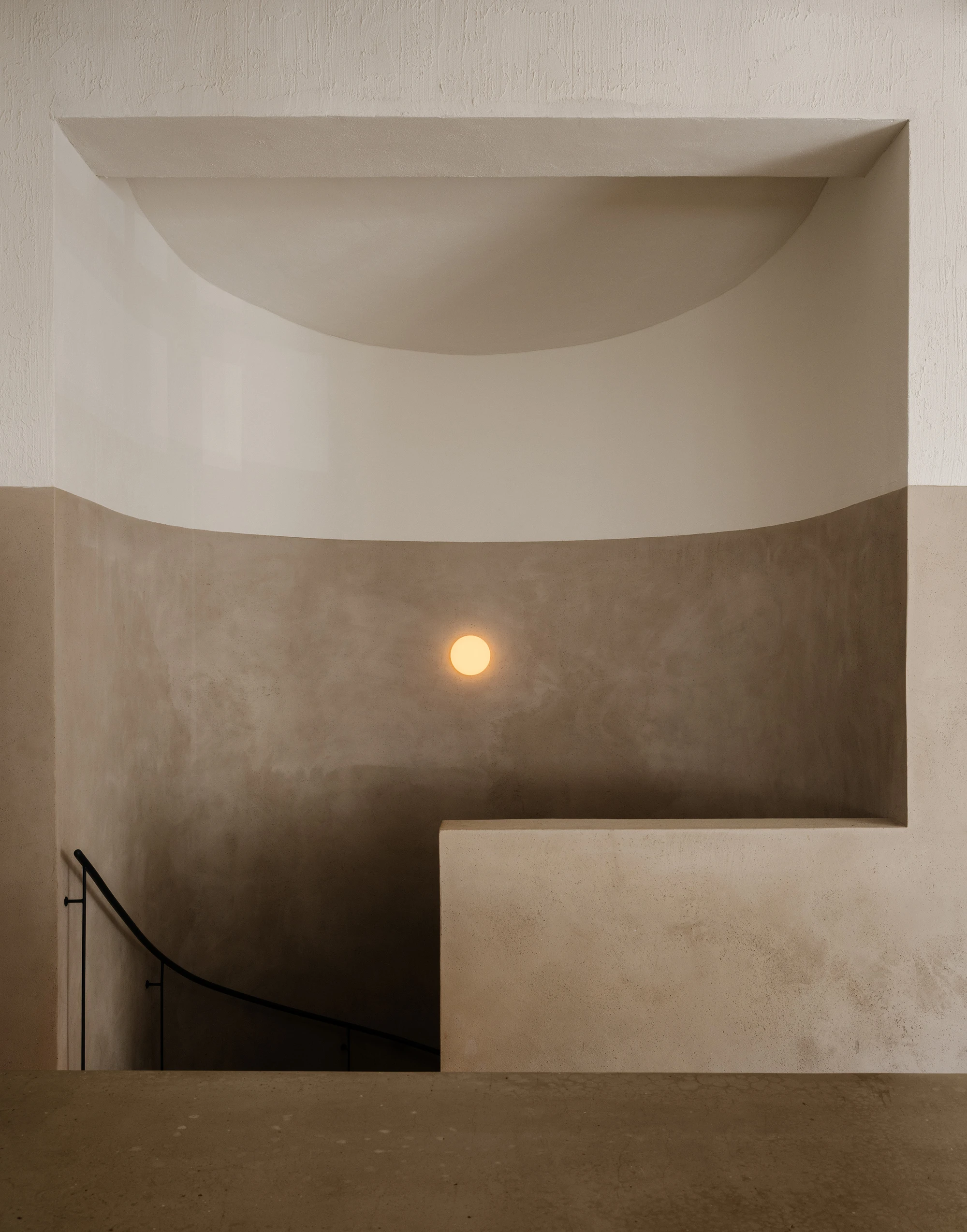 Stoke Restaurant by Studio Mark Randel — A stairwell descent captured from above reveals the architectural vocabulary of Stoke's interior.