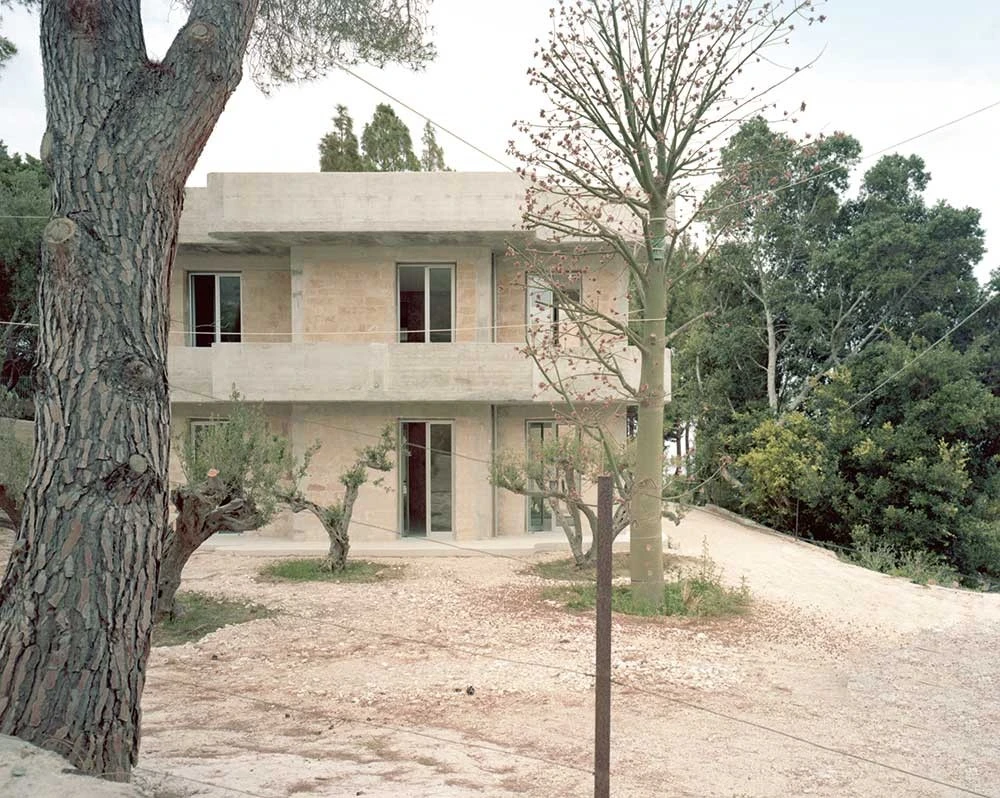 Guardia di Finanza by Brandlhuber+ — The Guardia di Finanza station presents itself as a two-story concrete structure set into a hillside landscape.