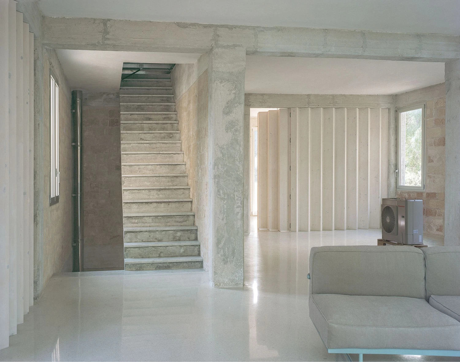Guardia di Finanza by Brandlhuber+ — Interior passage revealing the adaptive reuse strategy at the Guardia di Finanza station.