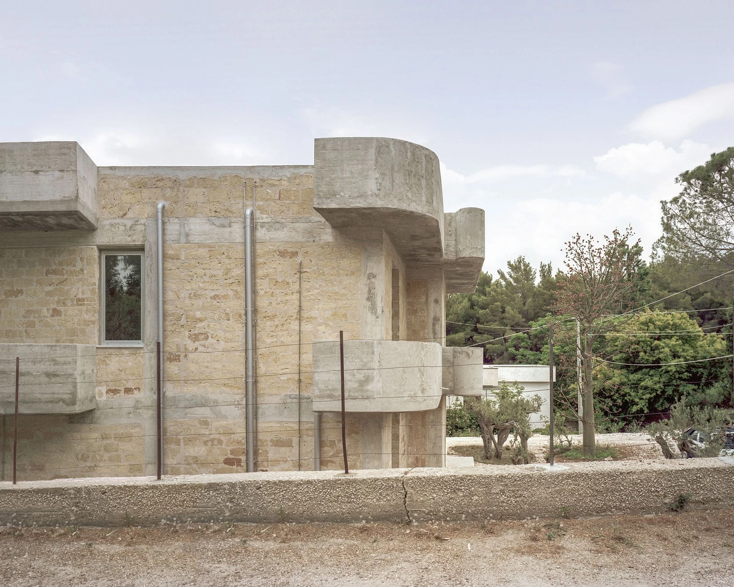 Guardia di Finanza by Brandlhuber+ — The former Guardia di Finanza station presents its brutalist facade in frontal elevation, revealing the structural logic of Michele di Simone's 1976 design.