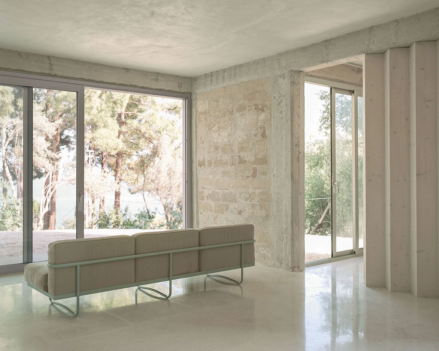 Guardia di Finanza by Brandlhuber+ — Interior view of the renovated Guardia di Finanza station showing a minimalist reception space.