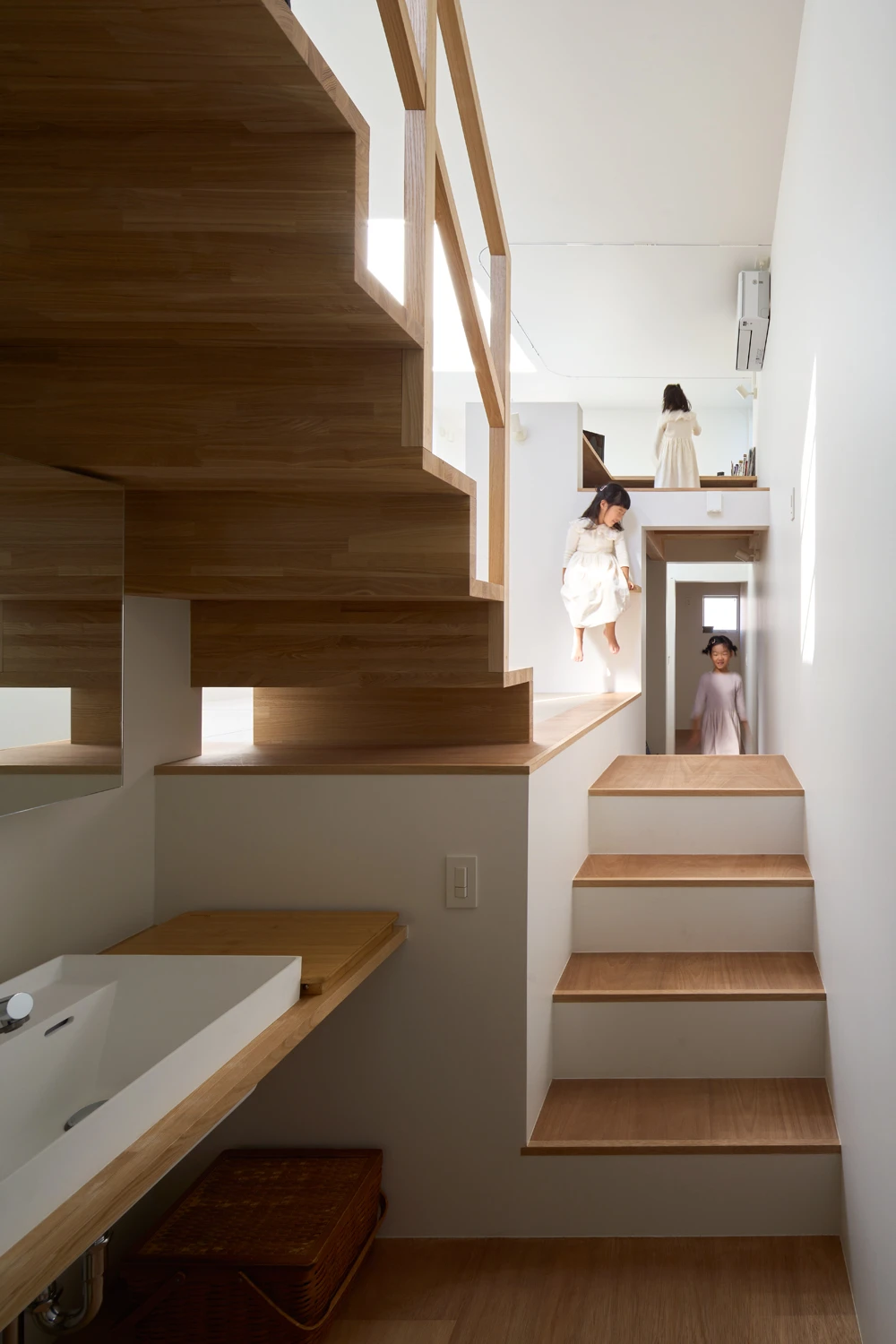 House in Hirano by Fujiwaramuro Architects — Interior staircase ascending through the flagpole lot's vertical core.