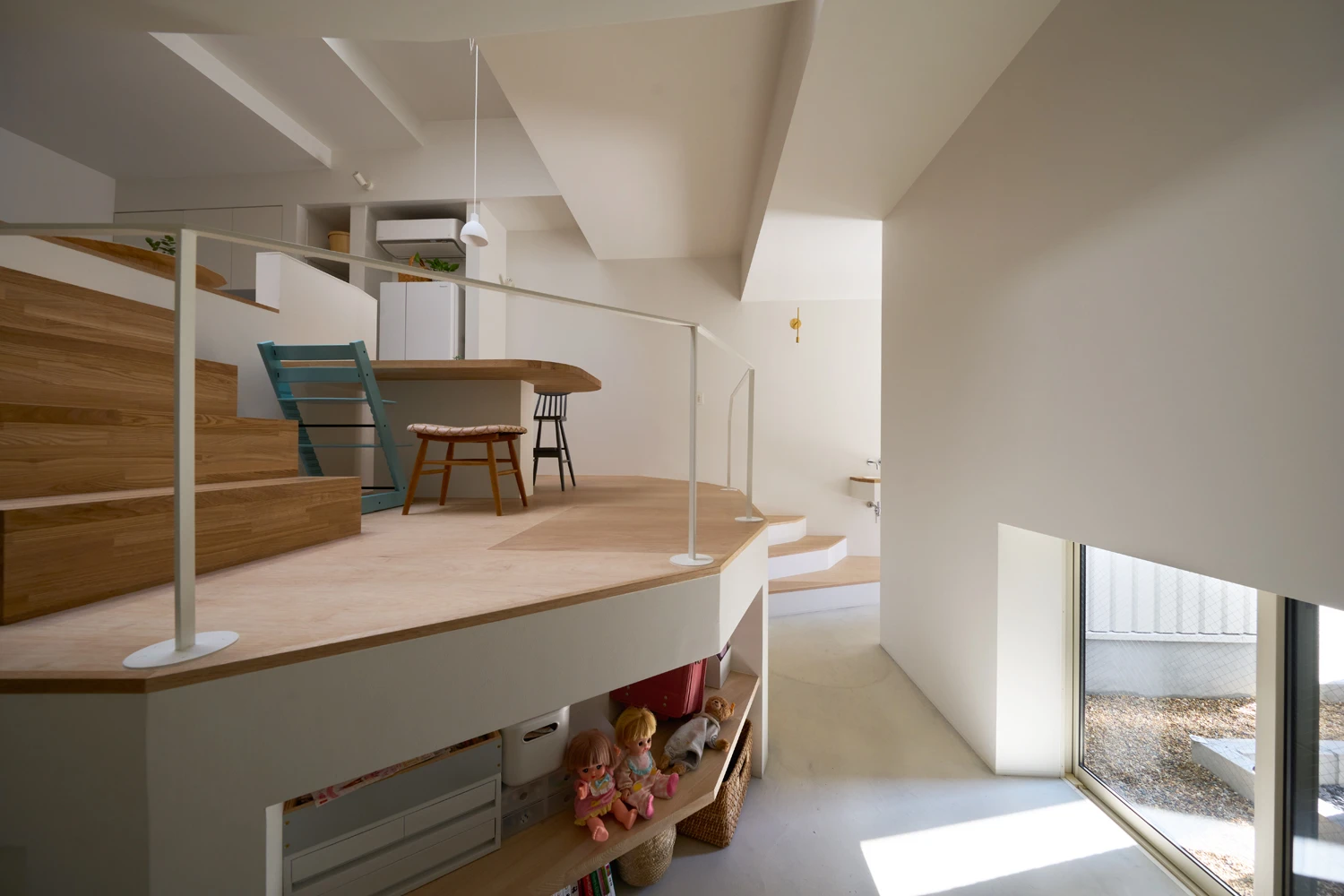 House in Hirano by Fujiwaramuro Architects — Interior view of the mezzanine level reveals how Fujiwaramuro Architects uses spatial layering to animate the constrained flagpole lot.