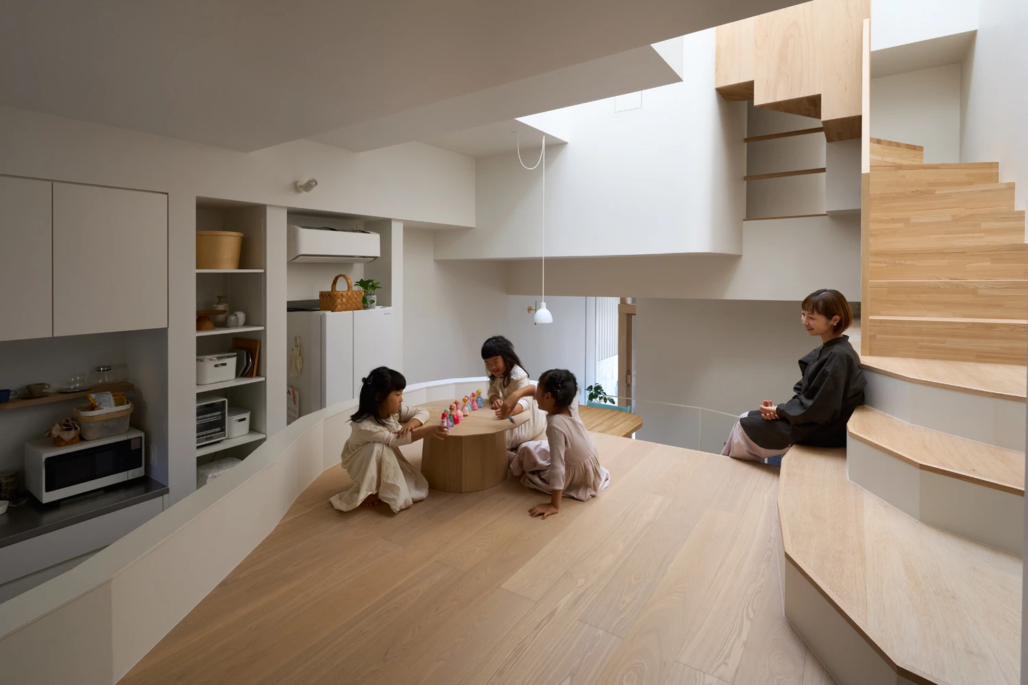 House in Hirano by Fujiwaramuro Architects — Interior view of a multi-story home compressed within a flagpole lot, where a continuous wood floor unifies disparate vertical zones.