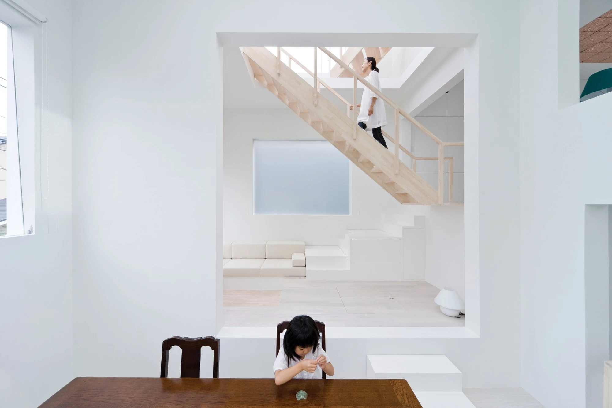 House H by Sou Fujimoto Architects — A compressed dining nook on the ground floor frames a vertical void extending through multiple levels of House H.