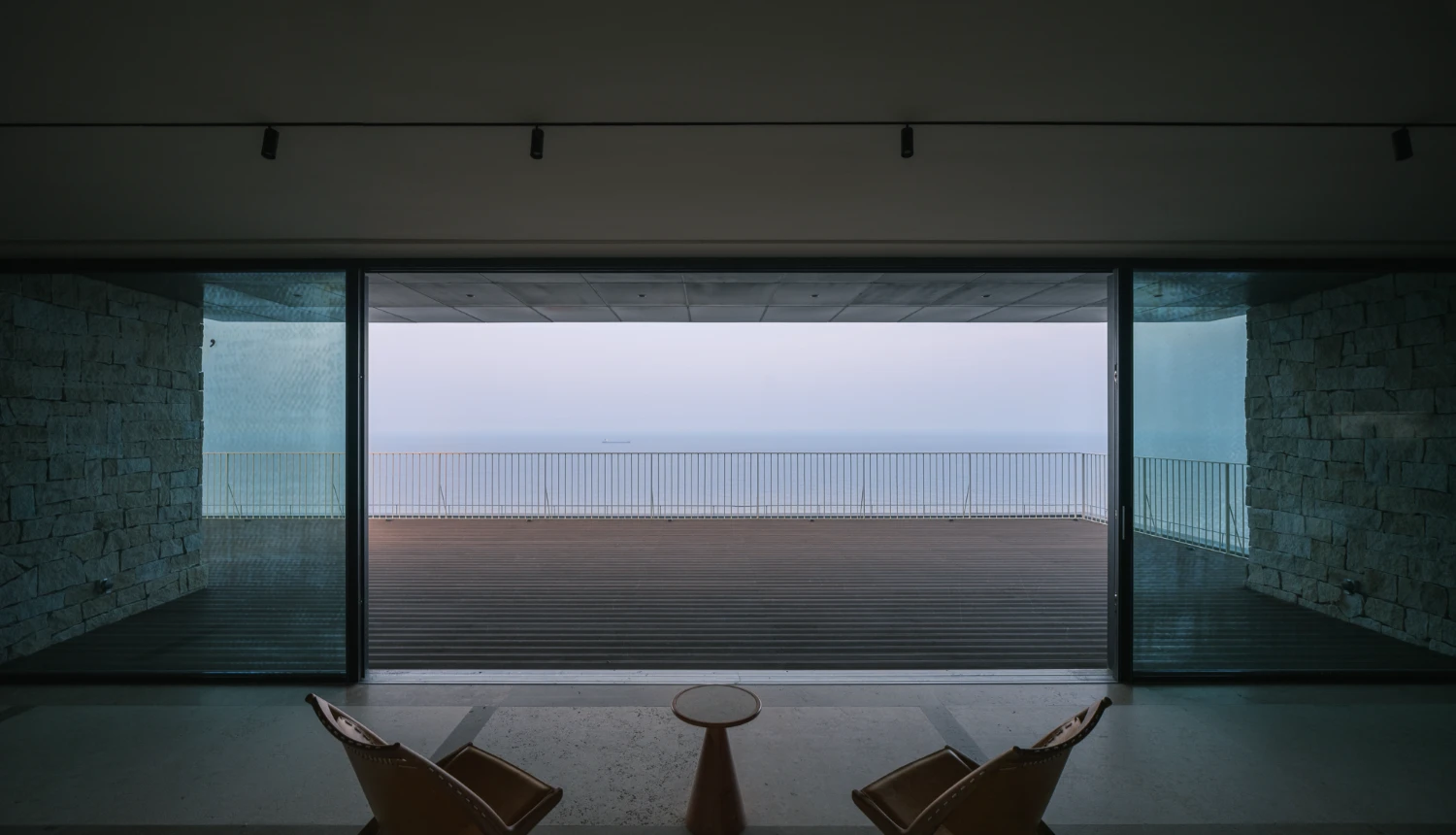 Lost Villa Shengsi Huanglong Island Lighthouse Hotel by SZ-Architects — A vast interior threshold frames the island's horizon through floor-to-ceiling glazing.