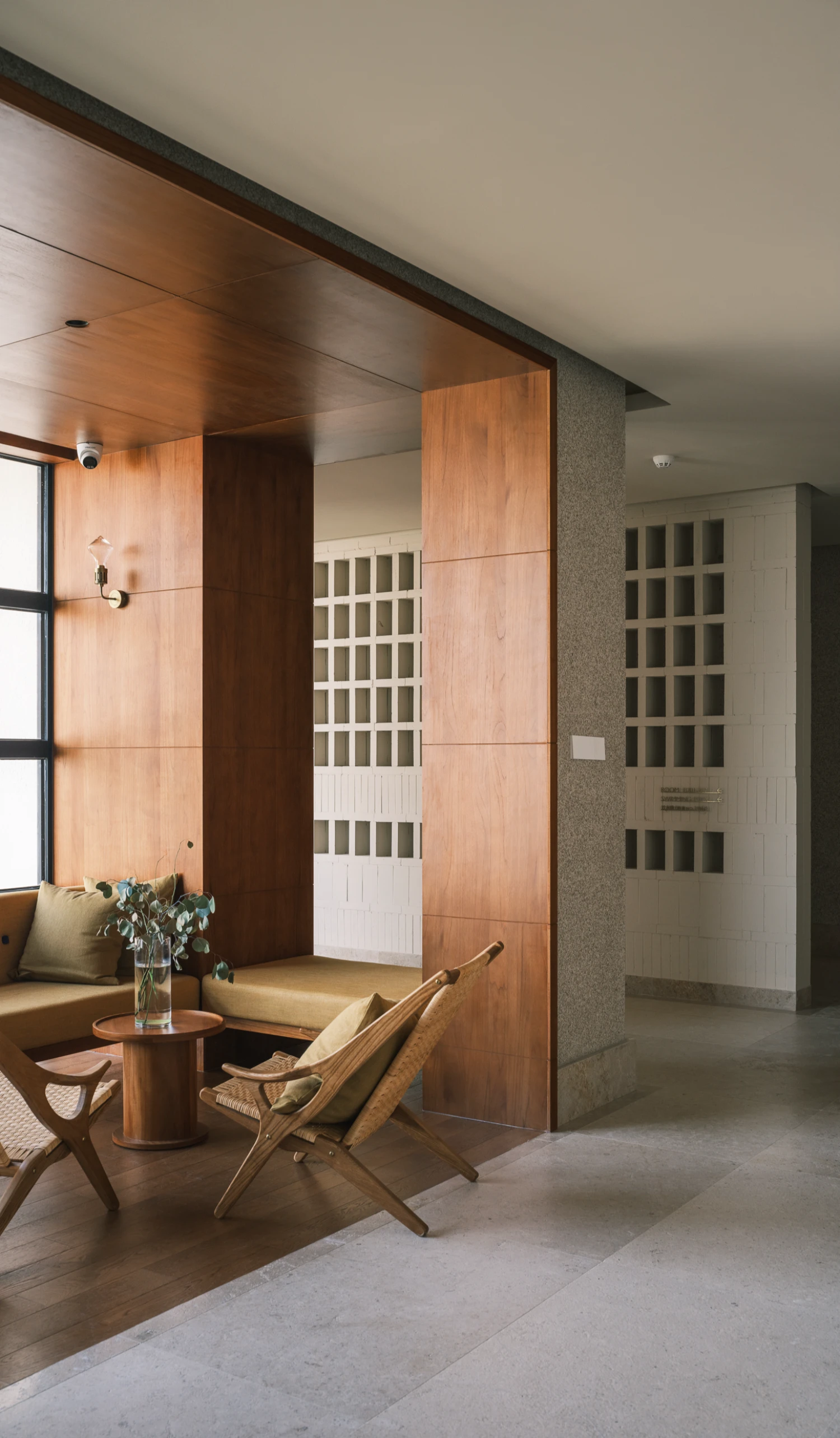 Lost Villa Shengsi Huanglong Island Lighthouse Hotel by SZ-Architects — A wooden-clad interior volume occupies the foreground, its warm timber panels creating a spatial partition within the larger atrium.