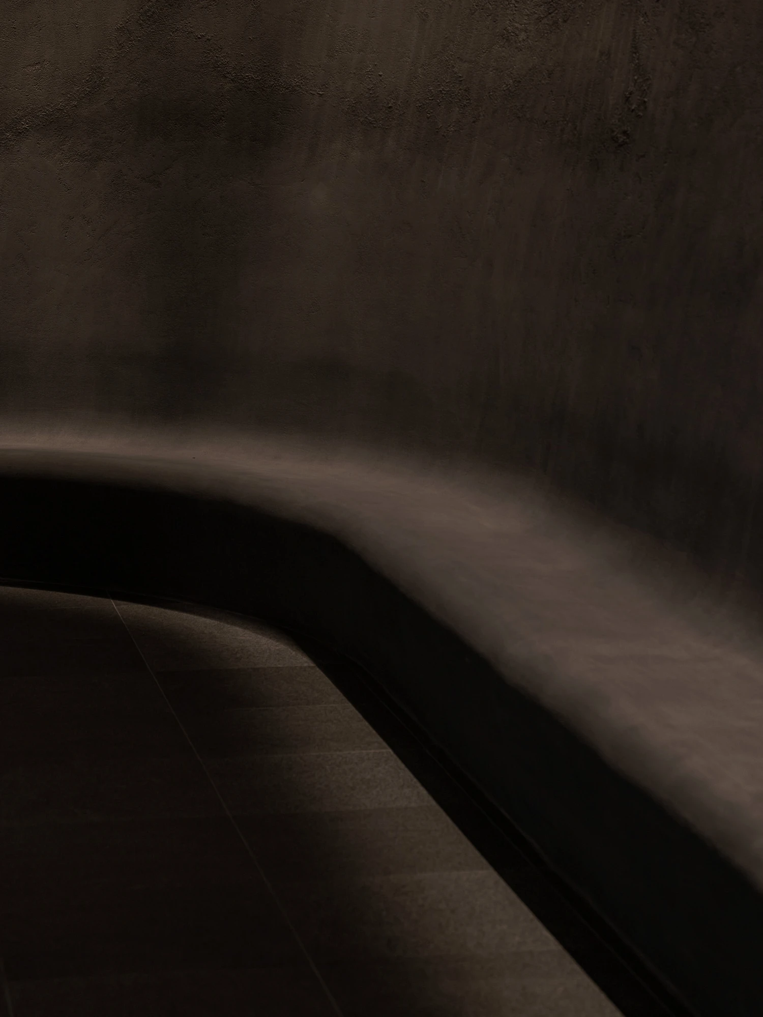 Baekje Gilt Bronze Incense Burner Hall (Buyeo National Museum) by WGNB — A curved concrete wall dominates the composition, its board-formed surface revealing aggregate texture and weathered finish.