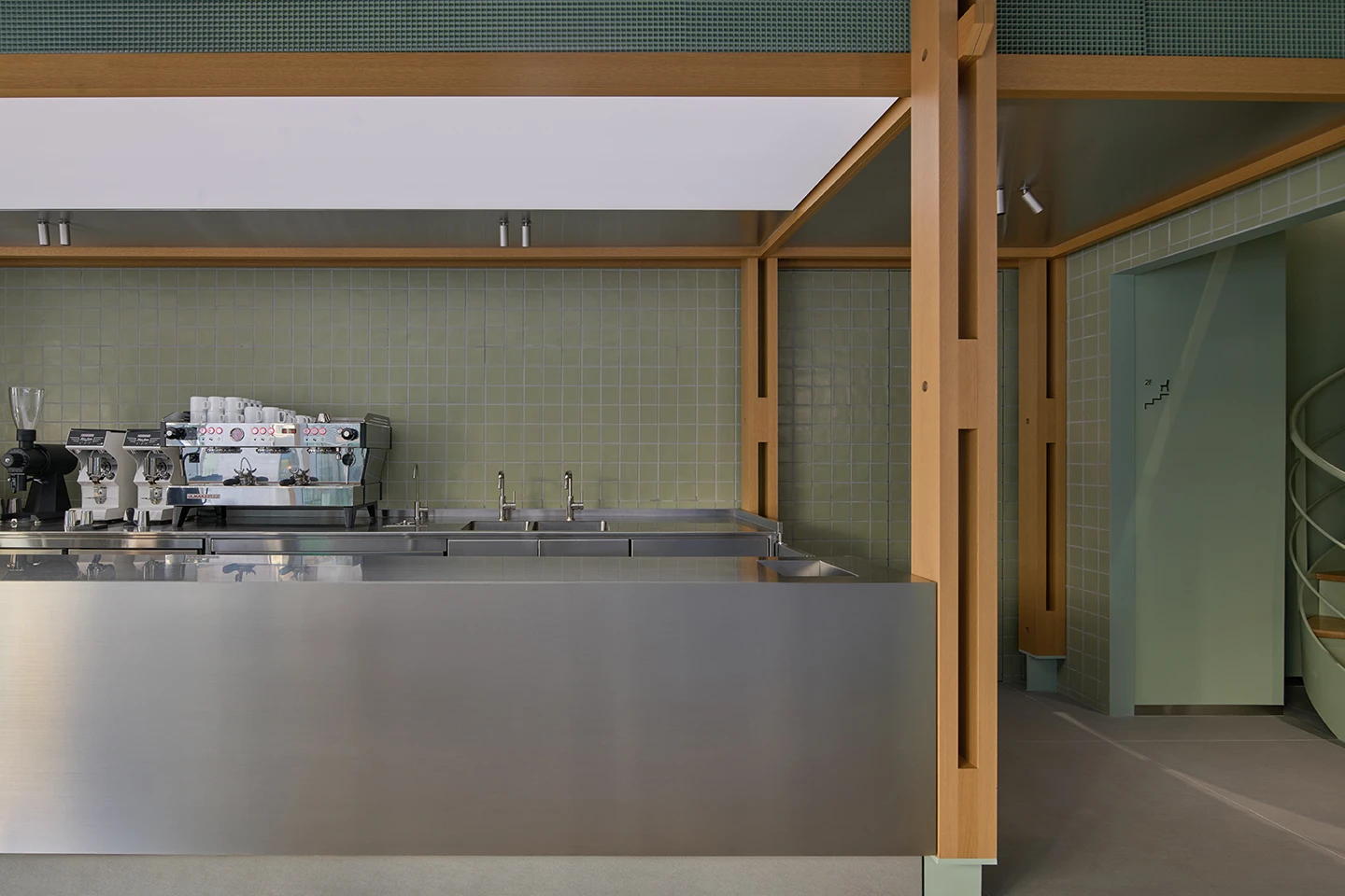 Alchemist Aoyama by Wynk Collaborative — The coffee counter operates as a framed pavilion, defined by a rhythmic post-and-beam structure in timber.