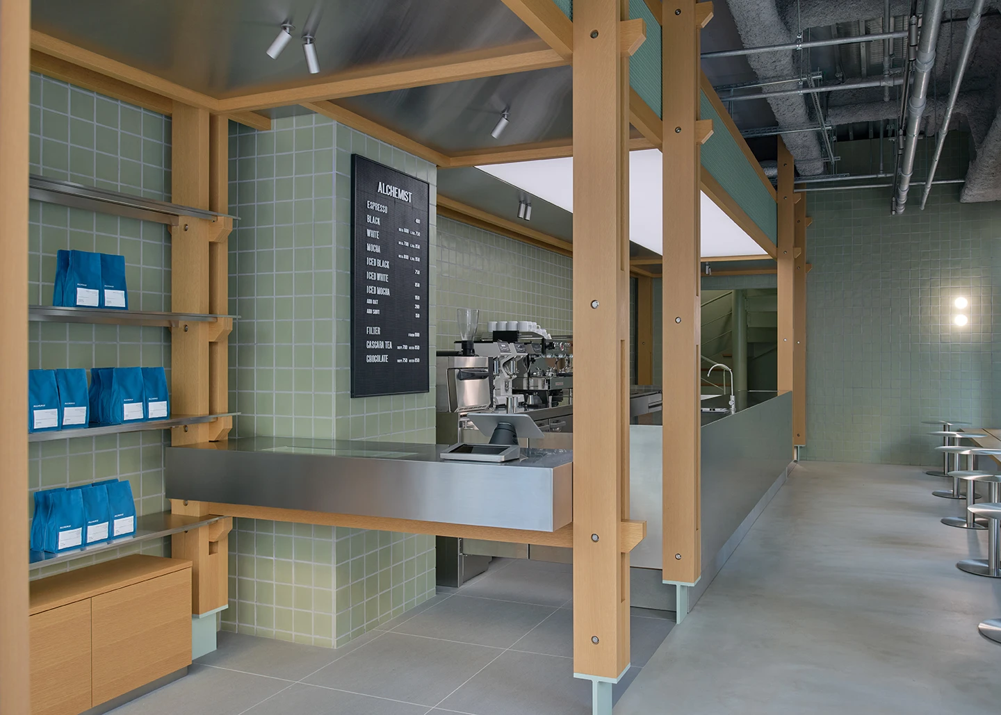 Alchemist Aoyama by Wynk Collaborative — The counter pavilion at Alchemist Aoyama is framed by a rhythmic post-and-beam structure in light oak, creating a defined threshold within the open ground...