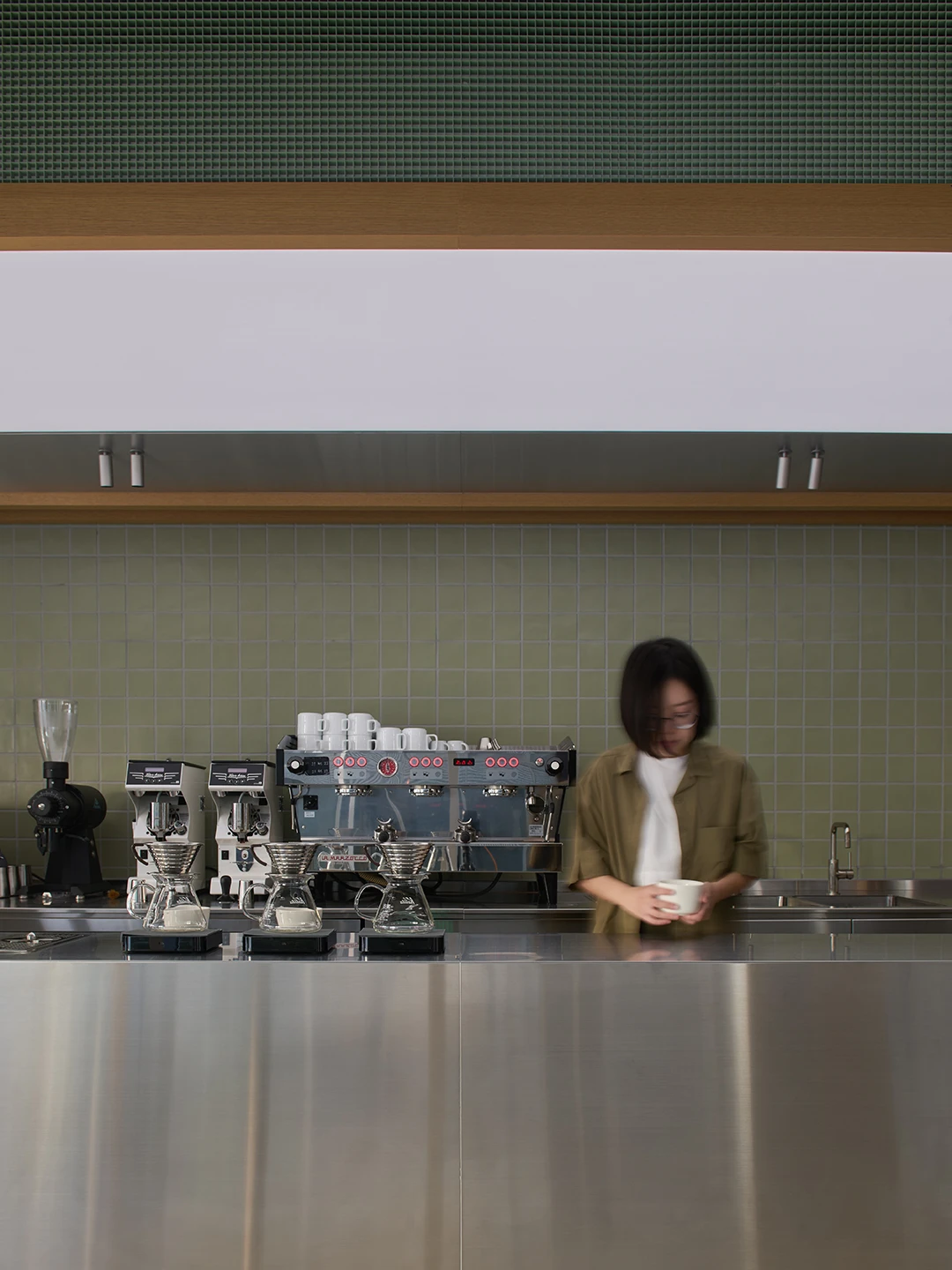 Alchemist Aoyama by Wynk Collaborative — The counter at Alchemist Aoyama positions a barista in profile, working within a precisely orchestrated service zone.