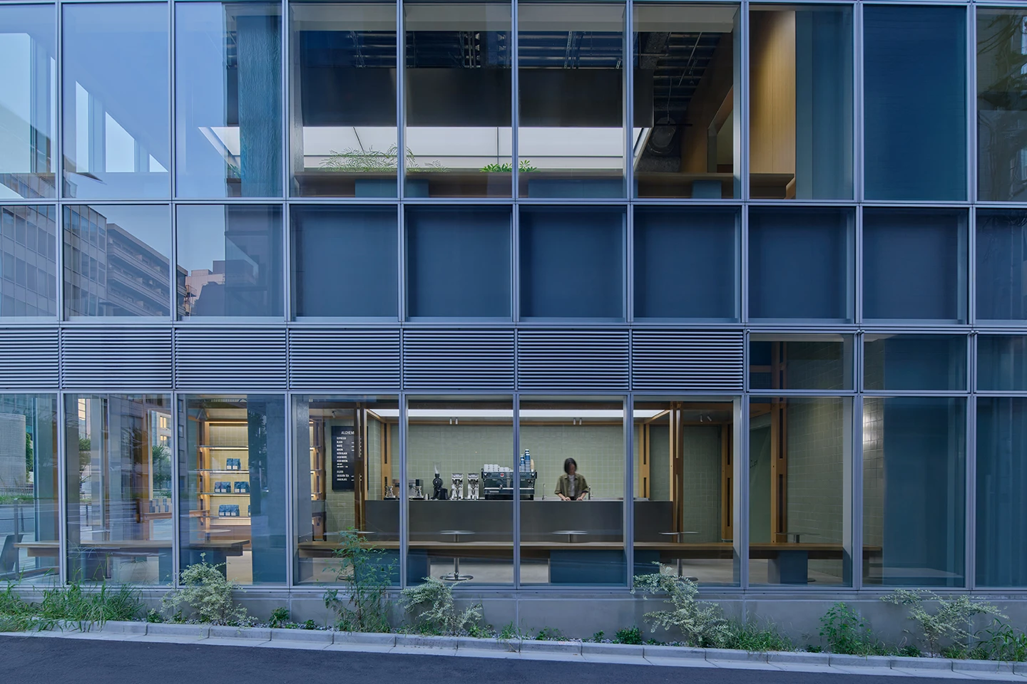 Alchemist Aoyama by Wynk Collaborative — The ground-floor threshold of Alchemist Aoyama presents a recessed storefront where transparency and layering orchestrate spatial depth.