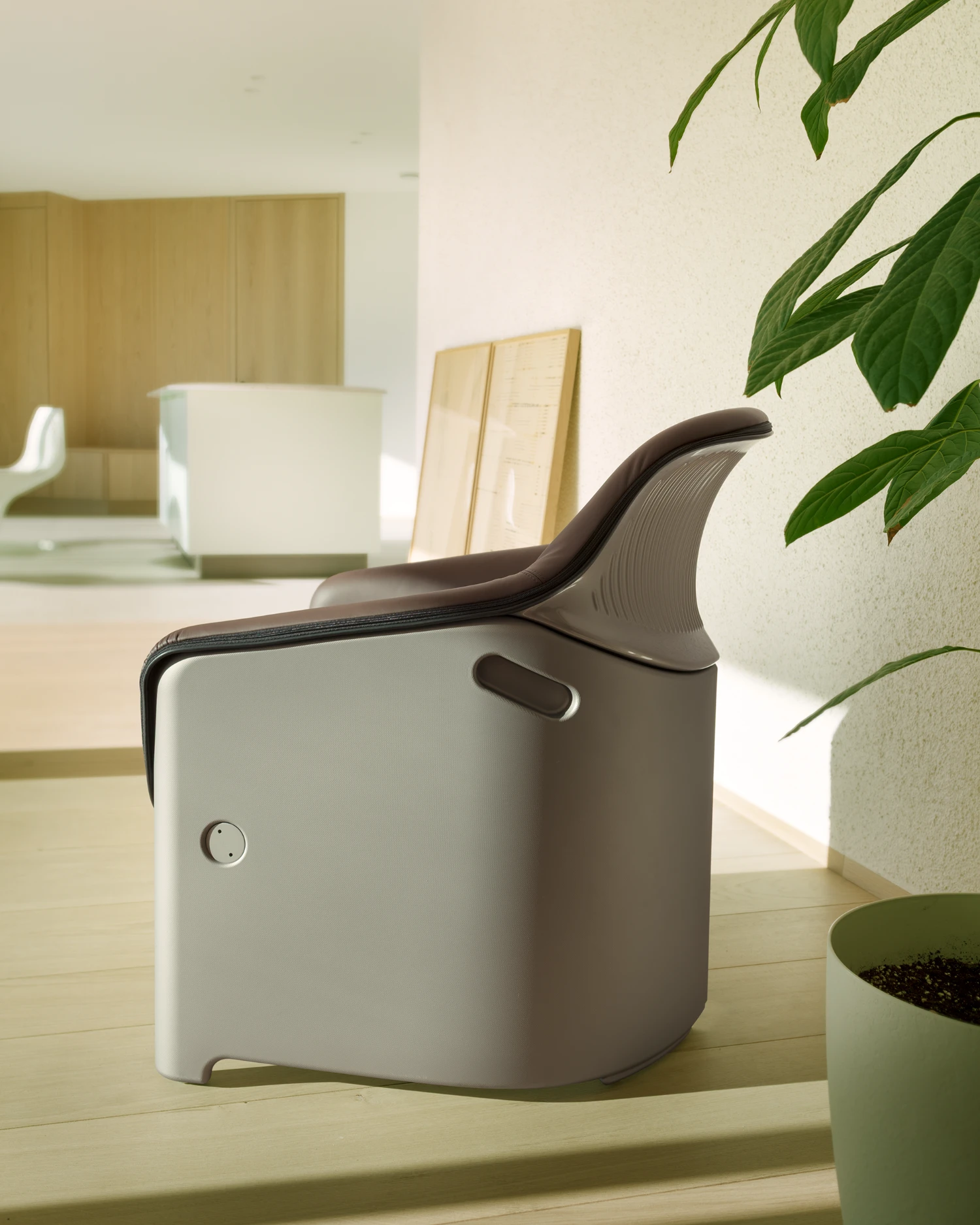 Casa Conte by Messner Architects — A close-up detail of a contemporary watering vessel in white ceramic with a dark brown leather handle curves gracefully across a light wooden surface.