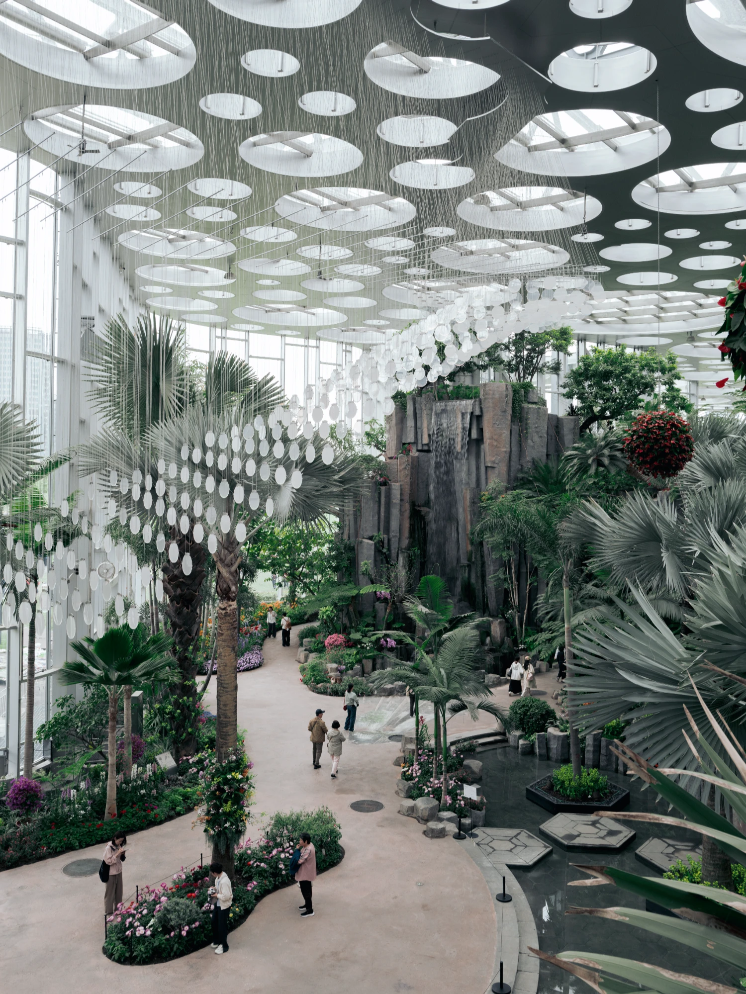 Expo Cultural Park Greenhouse Garden by Delugan Meissl captured by Marcus Yau — A vast greenhouse interior photographed from an elevated vantage point, revealing the spatial depth of Delugan Meissl's intervention.