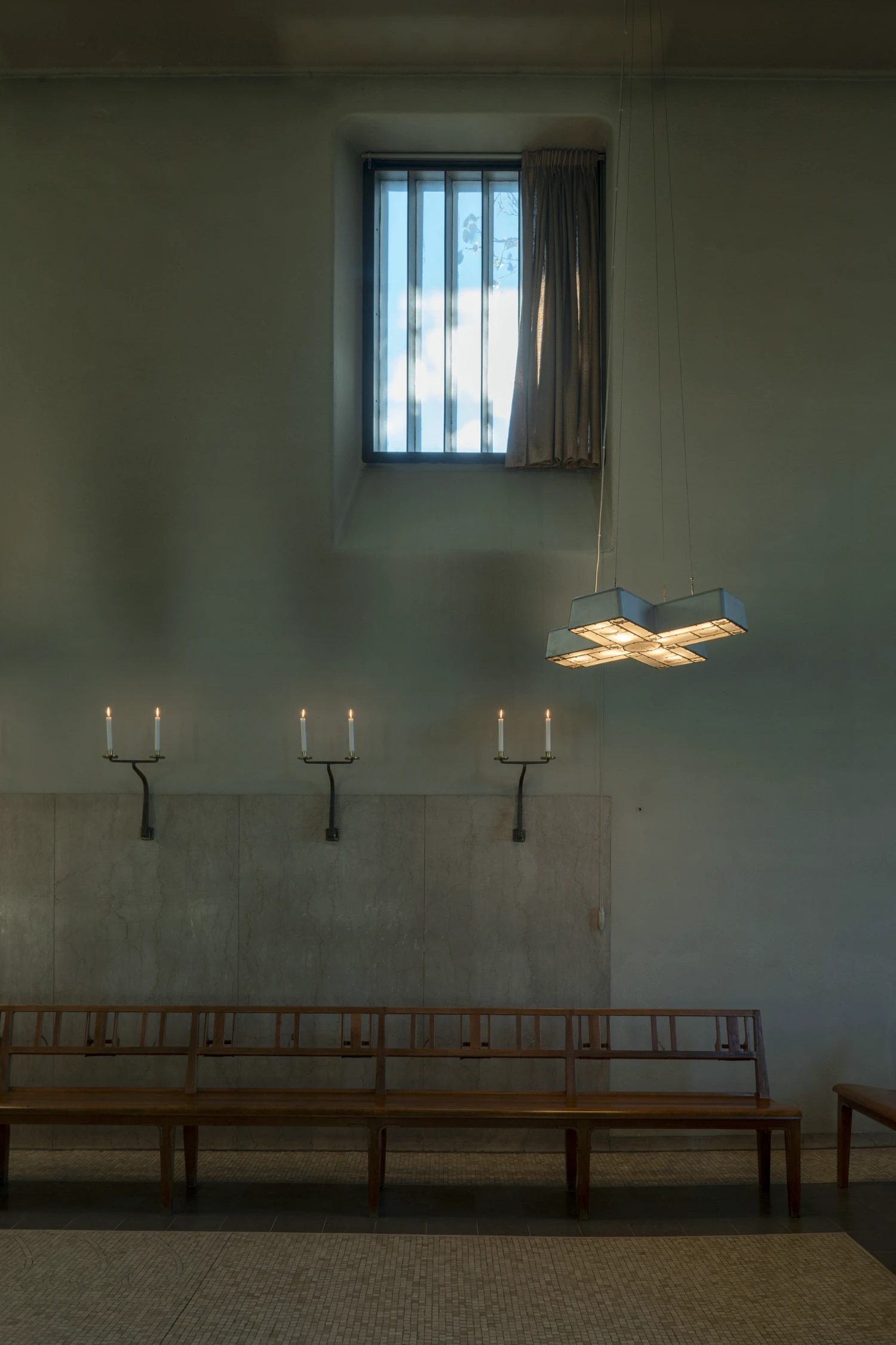 Woodland Cemetery Stockholm captured by Andy Liffner — Interior chapel space within Woodland Cemetery's chapel building, characterized by orthogonal simplicity and restrained ornamentation.