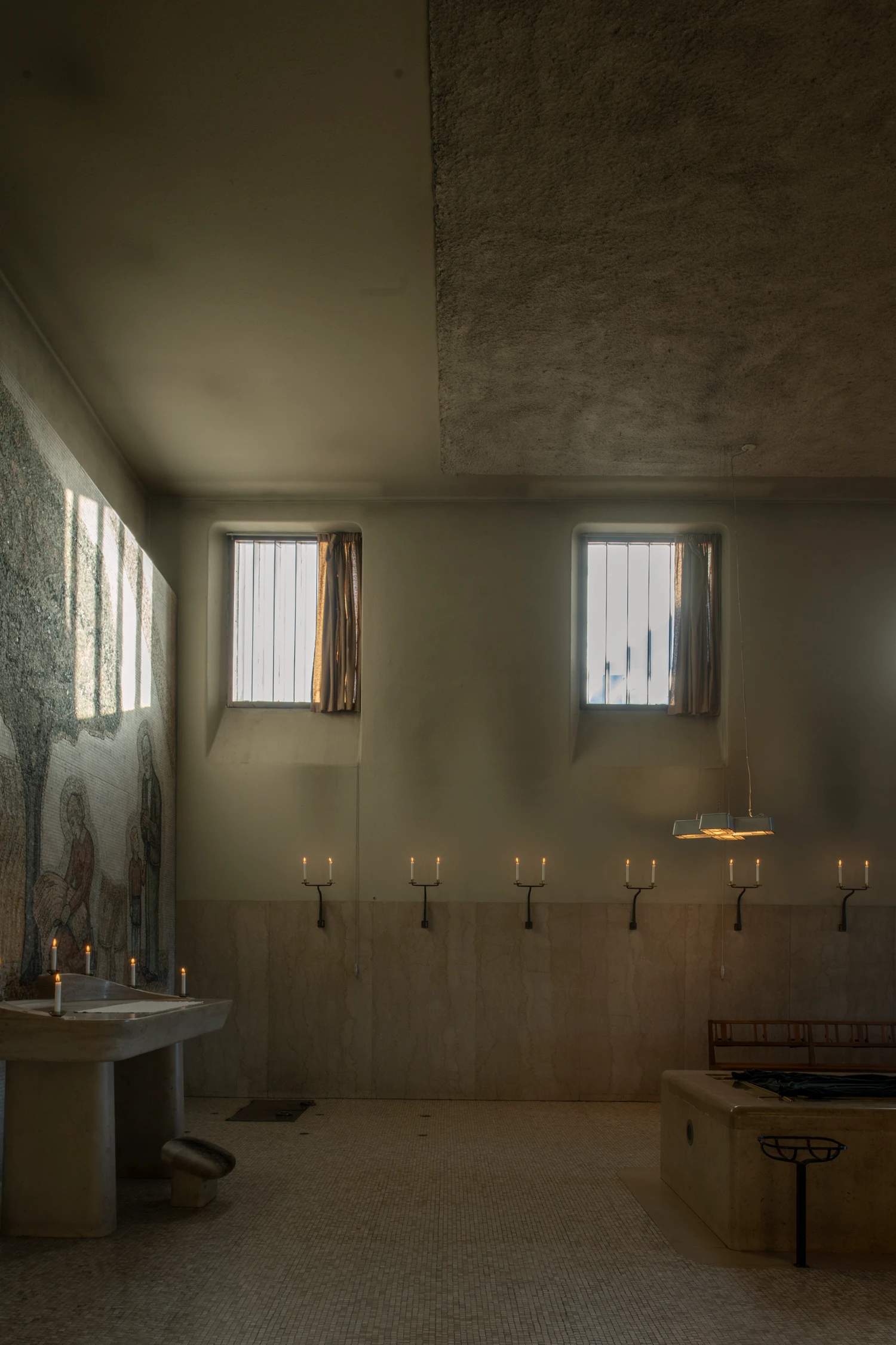 Woodland Cemetery Stockholm captured by Andy Liffner — A chapel interior suffused with northern light filtered through two barred windows.