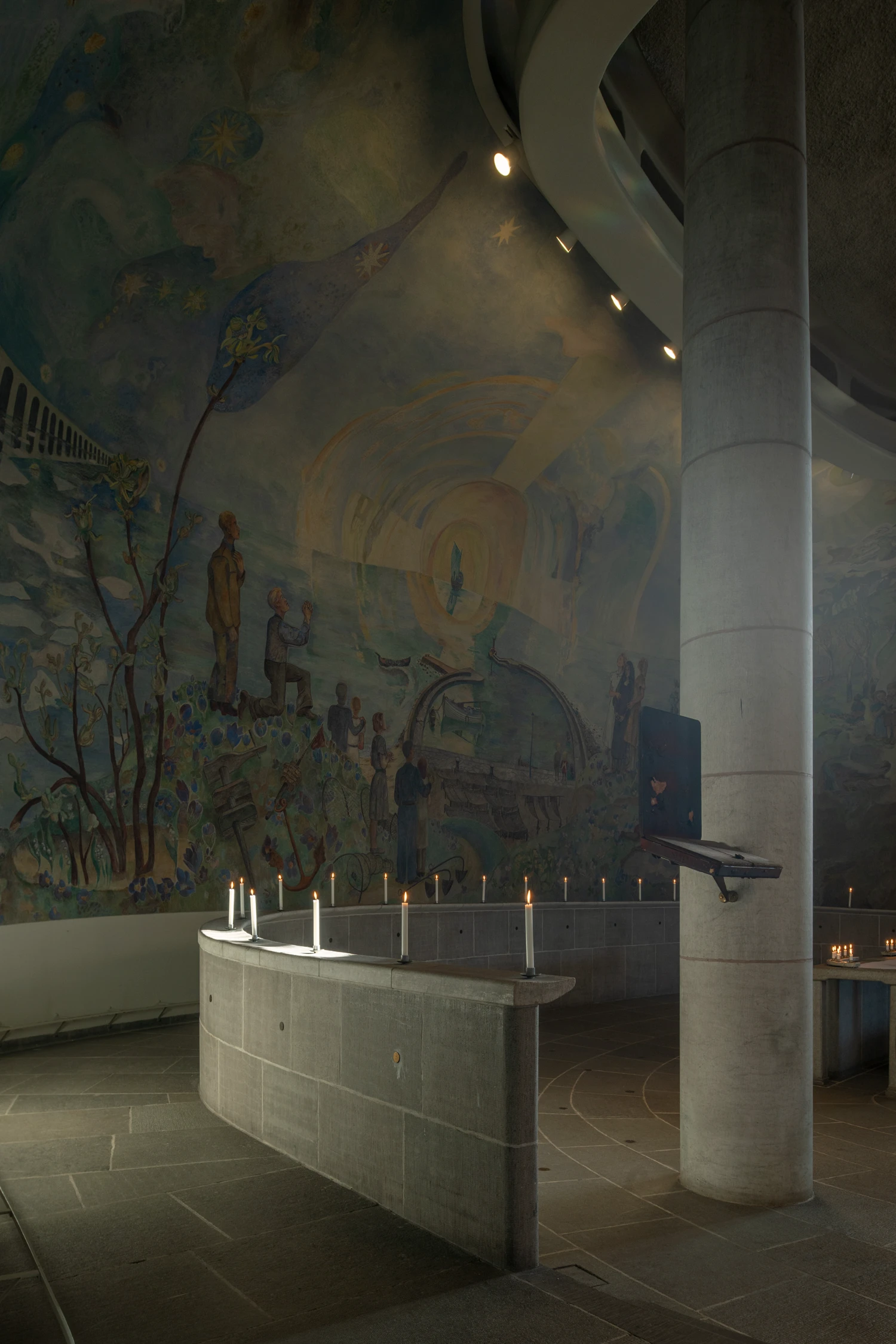 Woodland Cemetery Stockholm captured by Andy Liffner — Interior chapel space within Woodland Cemetery's chapel complex, captured in chiaroscuro lighting that emphasizes the monumental concrete column at right.