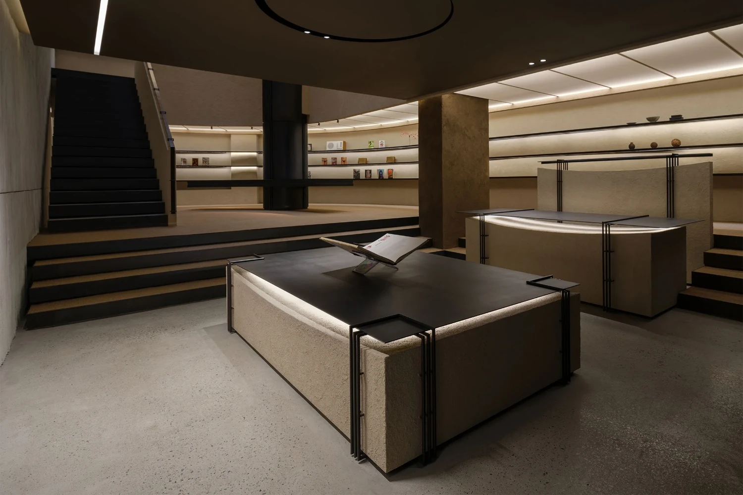 The Graphic bookstore by OONN Metaworks + U.LAB — The interior retail space employs a tiered, modular display system with illuminated shelving running the full perimeter.