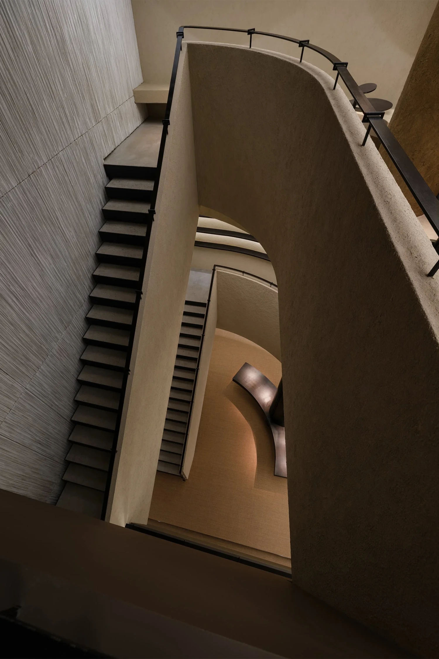 The Graphic bookstore by OONN Metaworks + U.LAB — A tilted interior view of The Graphic bookstore's multi-story stairwell reveals the building's geometric complexity.