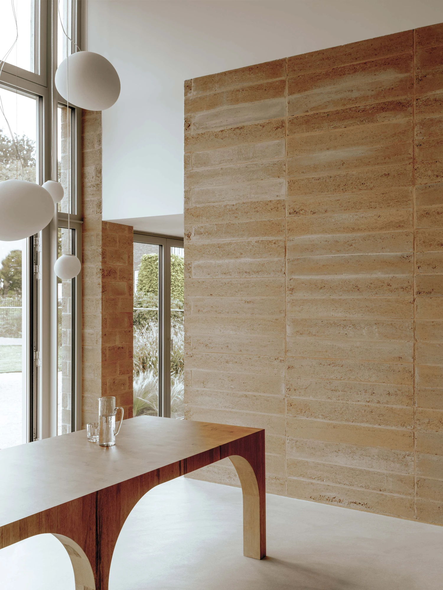 Residential House Weert by De Nieuwe Context — A dining space defined by material contrasts and horizontal layering.
