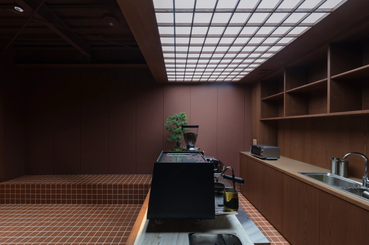 uru coffee by TRANSFORM — TRANSFORM's uru coffee interior demonstrates spatial compression through material restraint.