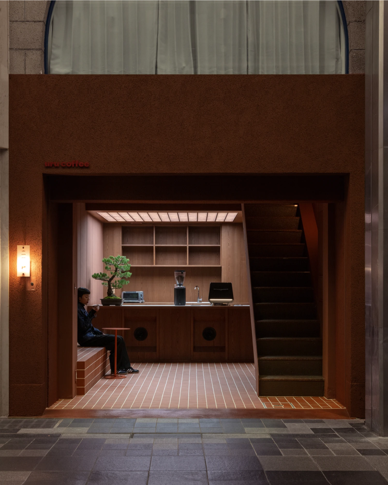 uru coffee by TRANSFORM — A compact retail interior captured from the street-facing threshold, revealing TRANSFORM's restrained spatial intervention.