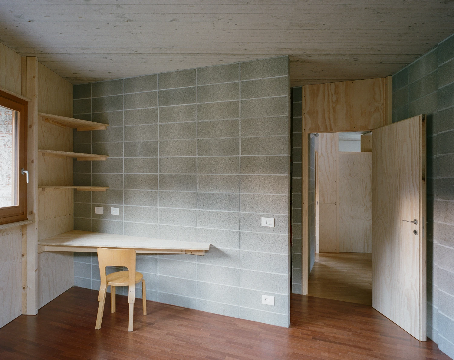 Casa BM by ErranteArchitetture — Interior workspace within Casa BM reveals a methodical approach to spatial partitioning.