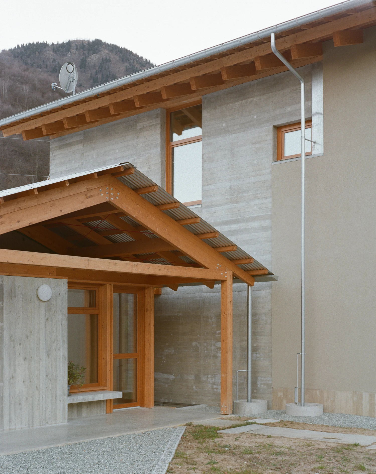 Casa BM by ErranteArchitetture — The garden elevation of Casa BM reveals the project's material stratification and spatial logic.