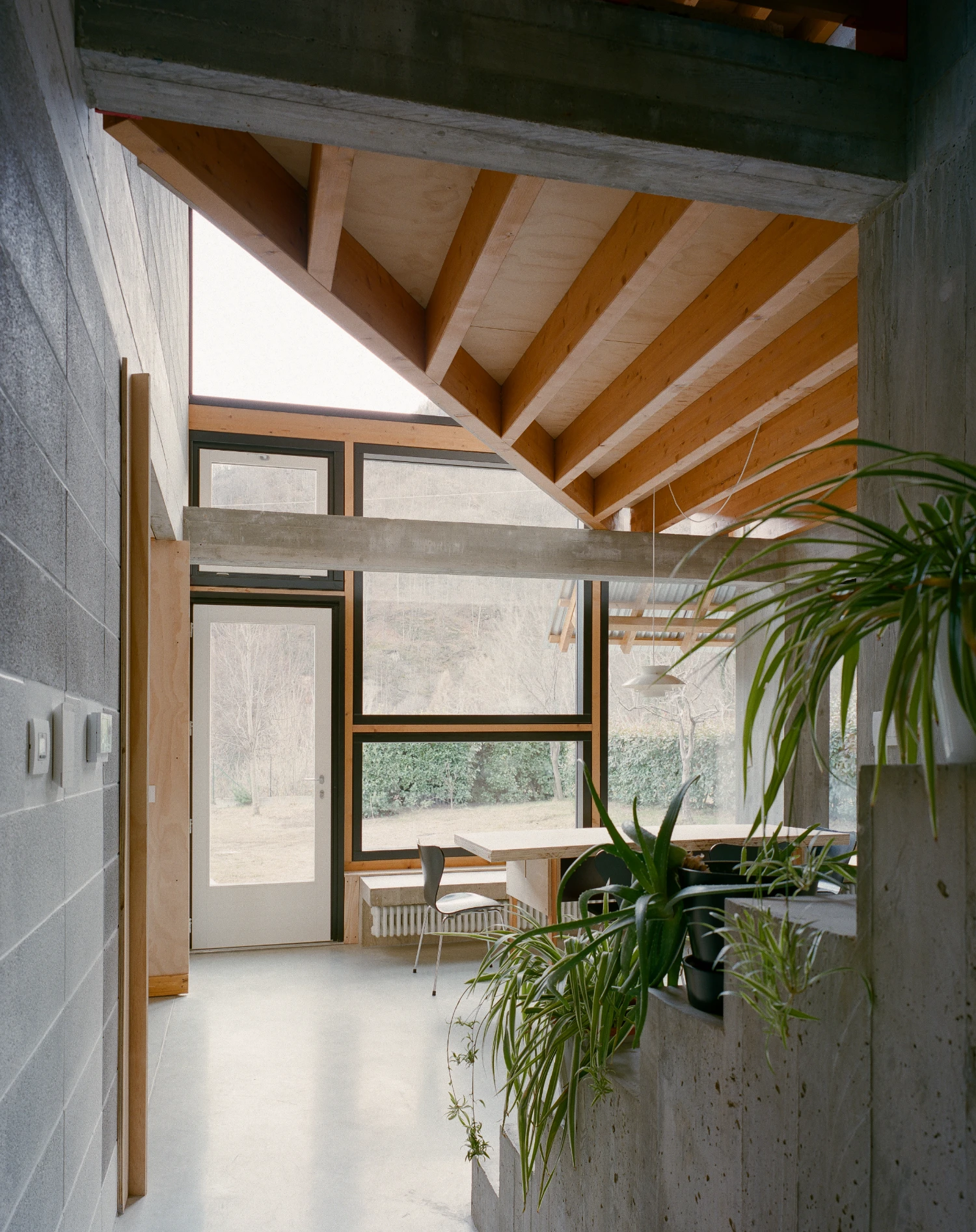 Casa BM by ErranteArchitetture — Interior view of the pavilion extension revealing the structural logic of Casa BM.