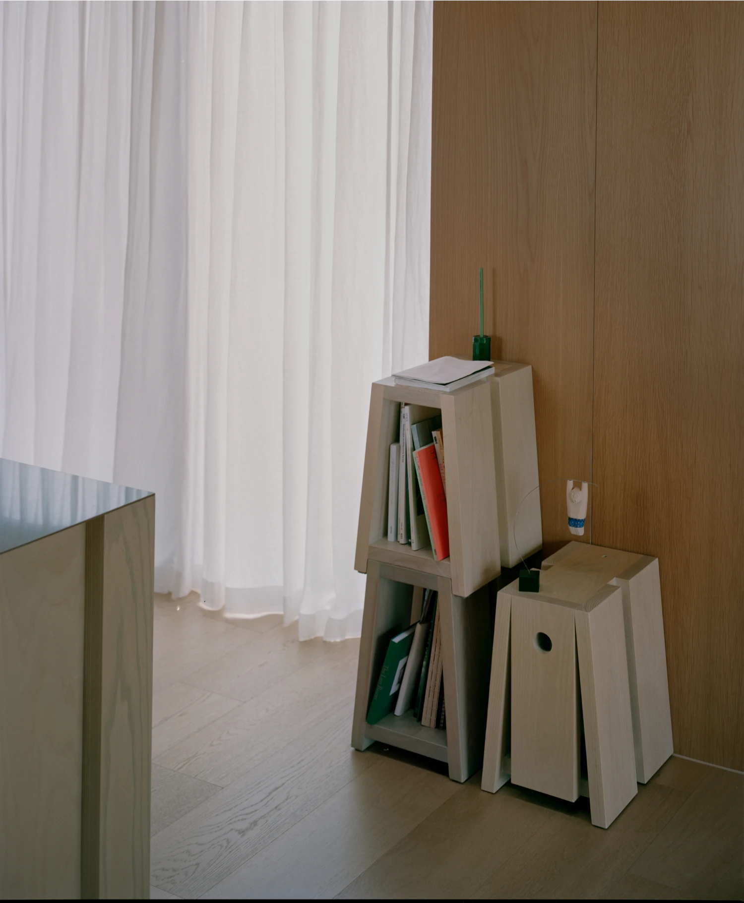 Hoji Gangneung Houses by AOA Architects captured by Danny Kai — A view into an interior corner of HOJI Gangneung, documenting modest storage solutions in pale timber.