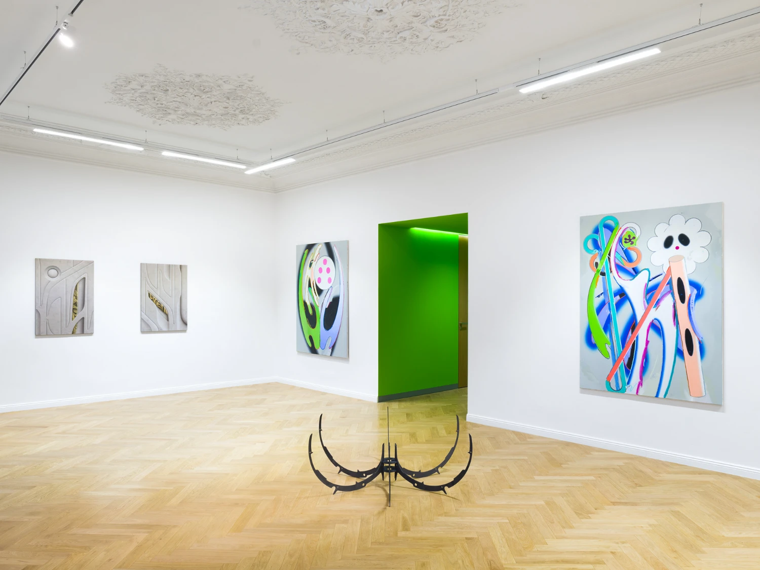 Bloom by Tomáš Absolon Milan Vagač at SPOT Gallery — The gallery interior reveals a spatial configuration organized around two symmetrical black steel floor sculptures with paired crescent forms.