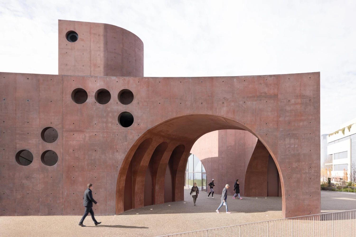 Wagner Park Pavilion by Thomas Phifer — A monumental concrete pavilion presents twin curved archways framing a passage through its mass.