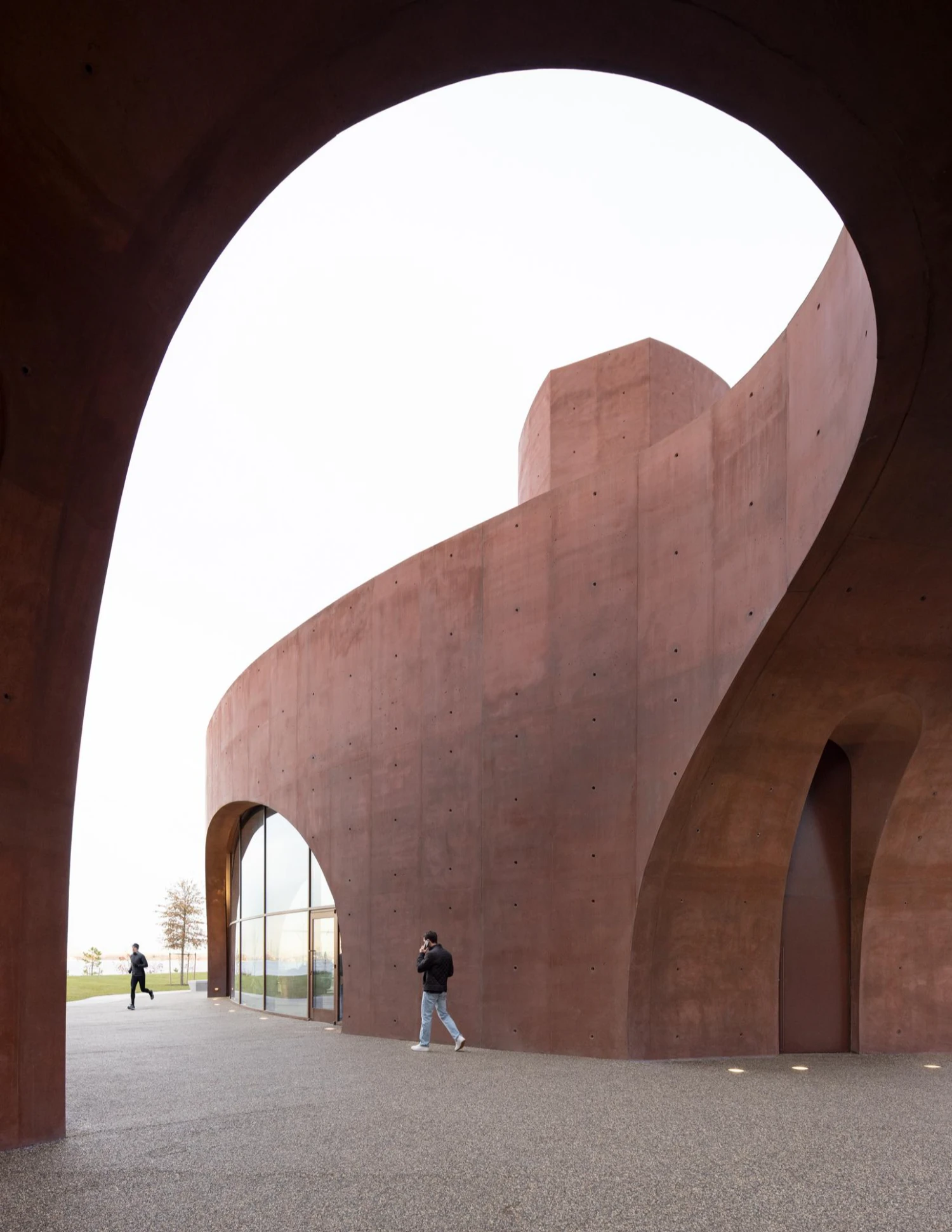 Wagner Park Pavilion by Thomas Phifer — Viewed from within the pavilion's northern passage, the monumental twin archways frame the landscape beyond in dramatic silhouette.