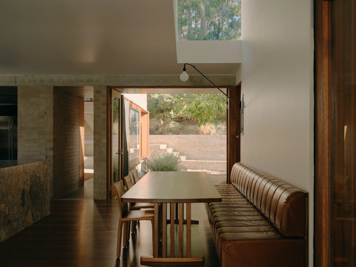 Stuartholme House by Nielsen Jenkins + Michael Lumby — The dining threshold frames a linear progression from interior to landscape.