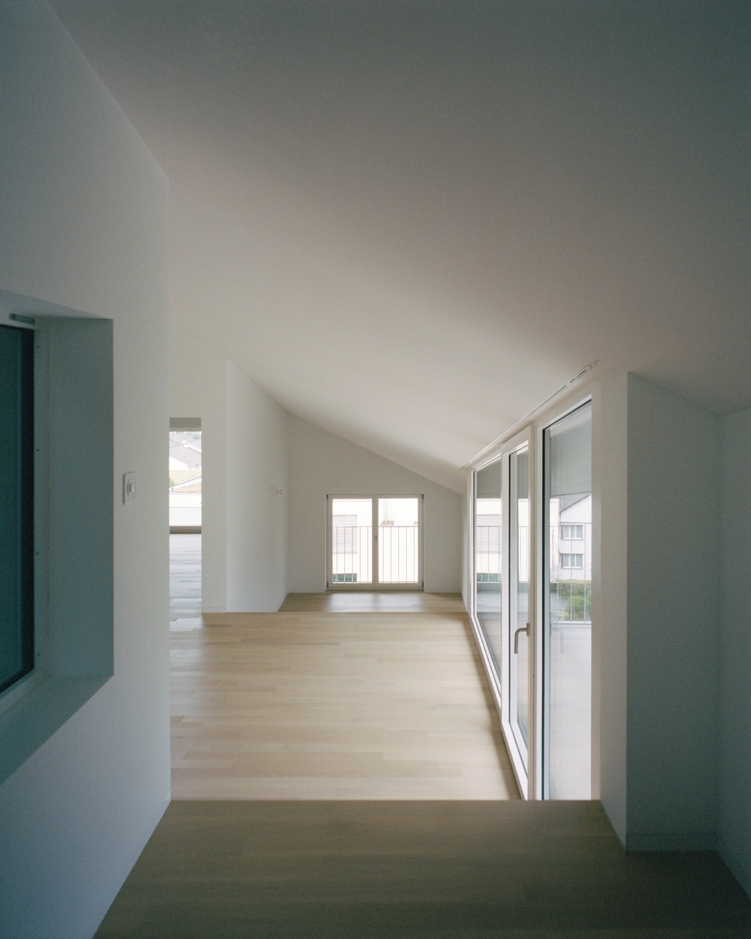 House on a Slope by KARAMUK KUO — A bright residential corridor showcasing the project's internal spatial organization.