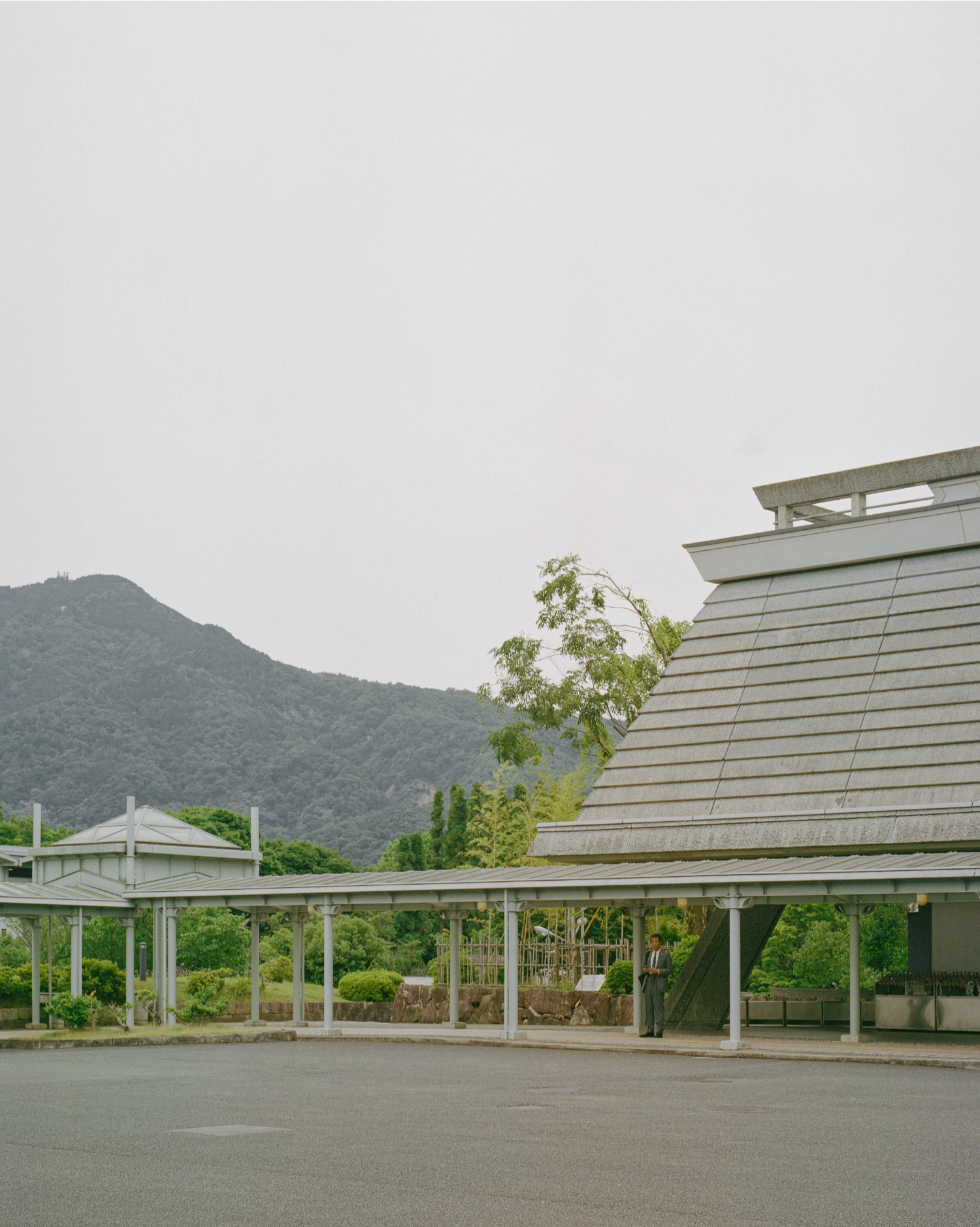 Kyoto International Conference Center by Sachio Otani captured by Brook James — Brook James captures the Kyoto International Conference Center's cantilevered concrete planes in overcast daylight, emphasizing the building's geometric...