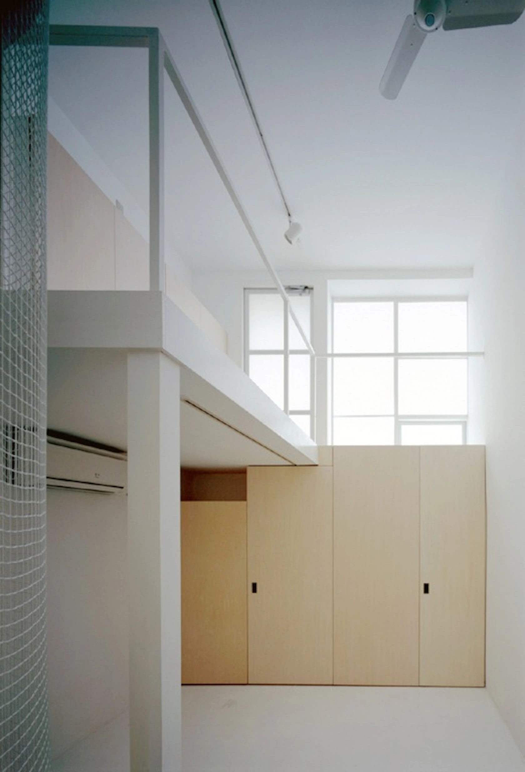 Long Tall House by Spacespace — Interior view of a multi-storey residential space defined by floor-to-ceiling timber panel walls in light wood tones.