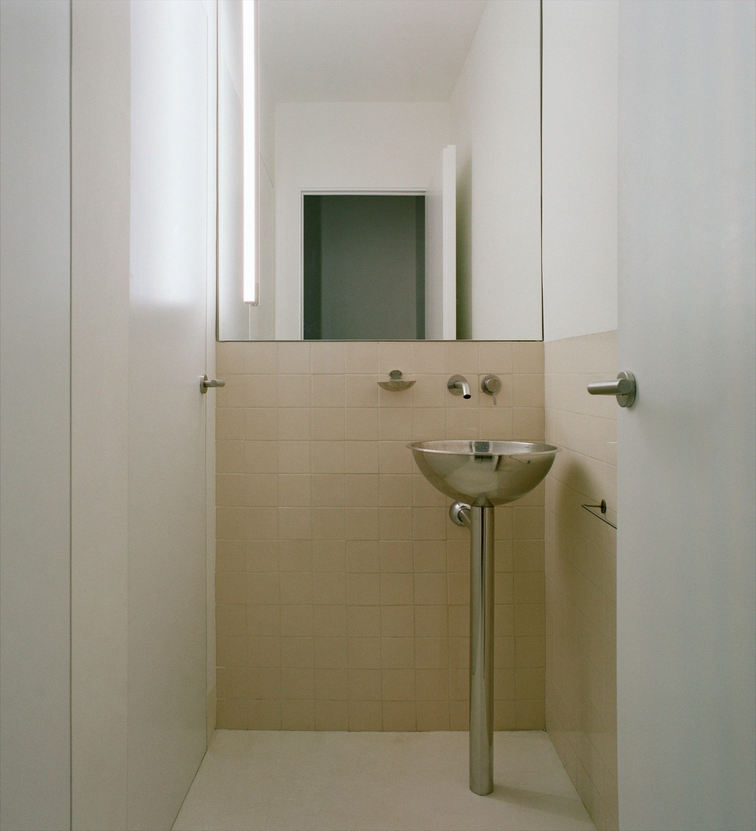 LL731 by Aramé Studio — A minimalist bathroom within the LL731 residence demonstrates material restraint and functional clarity.